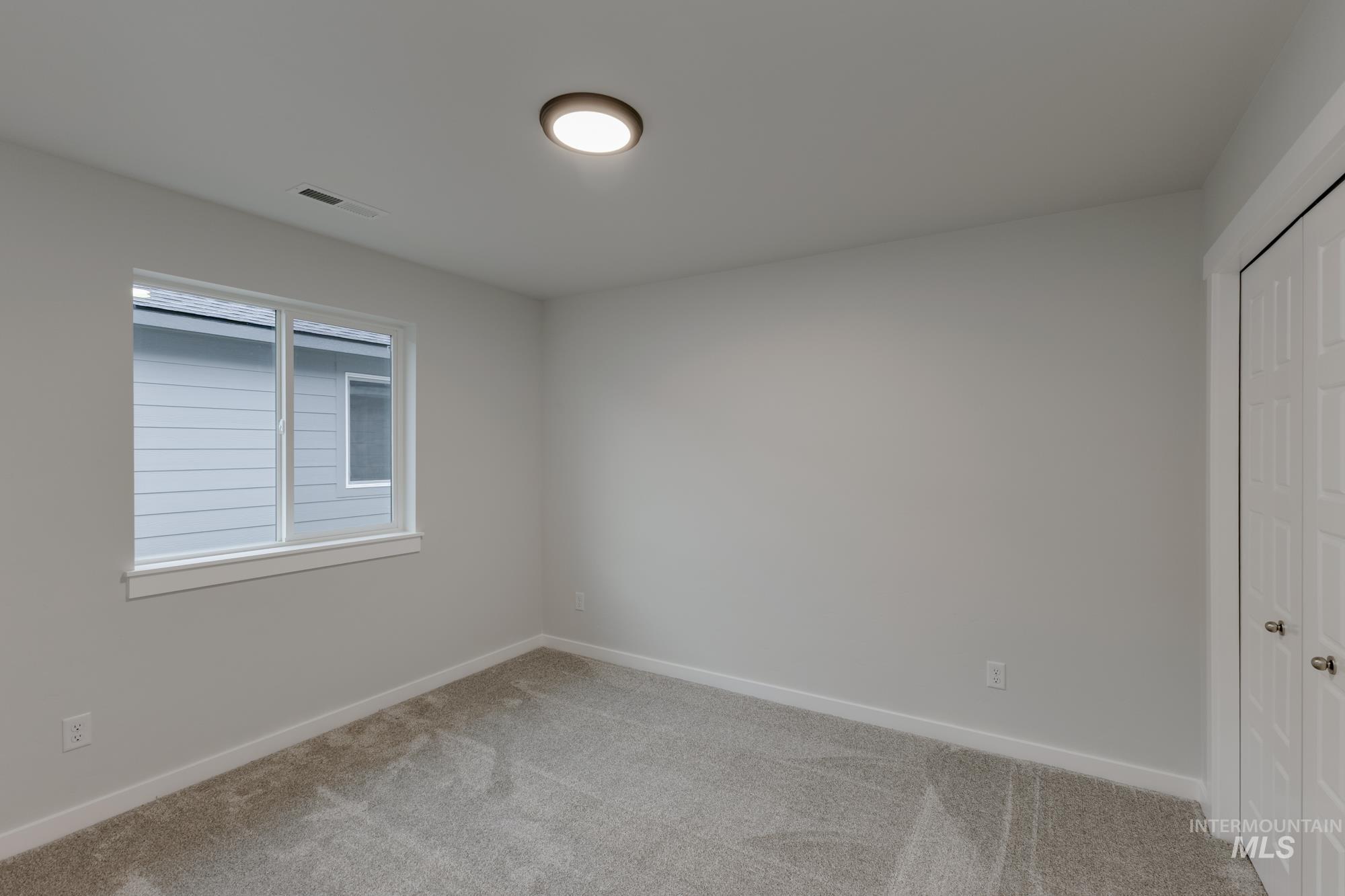 Unfurnished bedroom featuring carpet and a closet