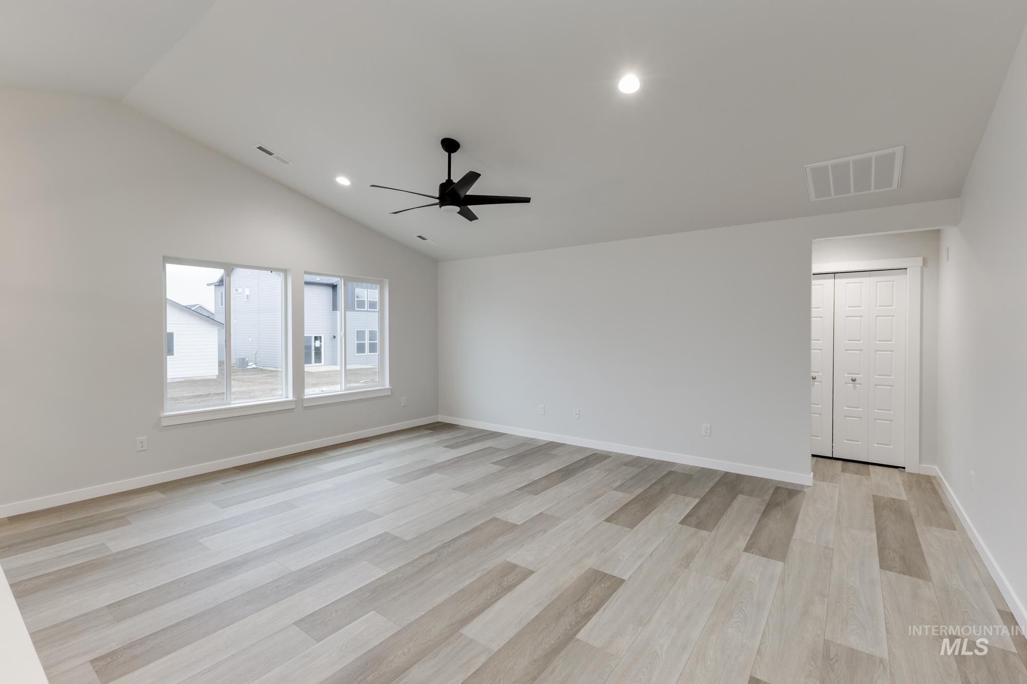 Empty room featuring recessed lighting, light wood finished floors, vaulted ceiling, and ceiling fan