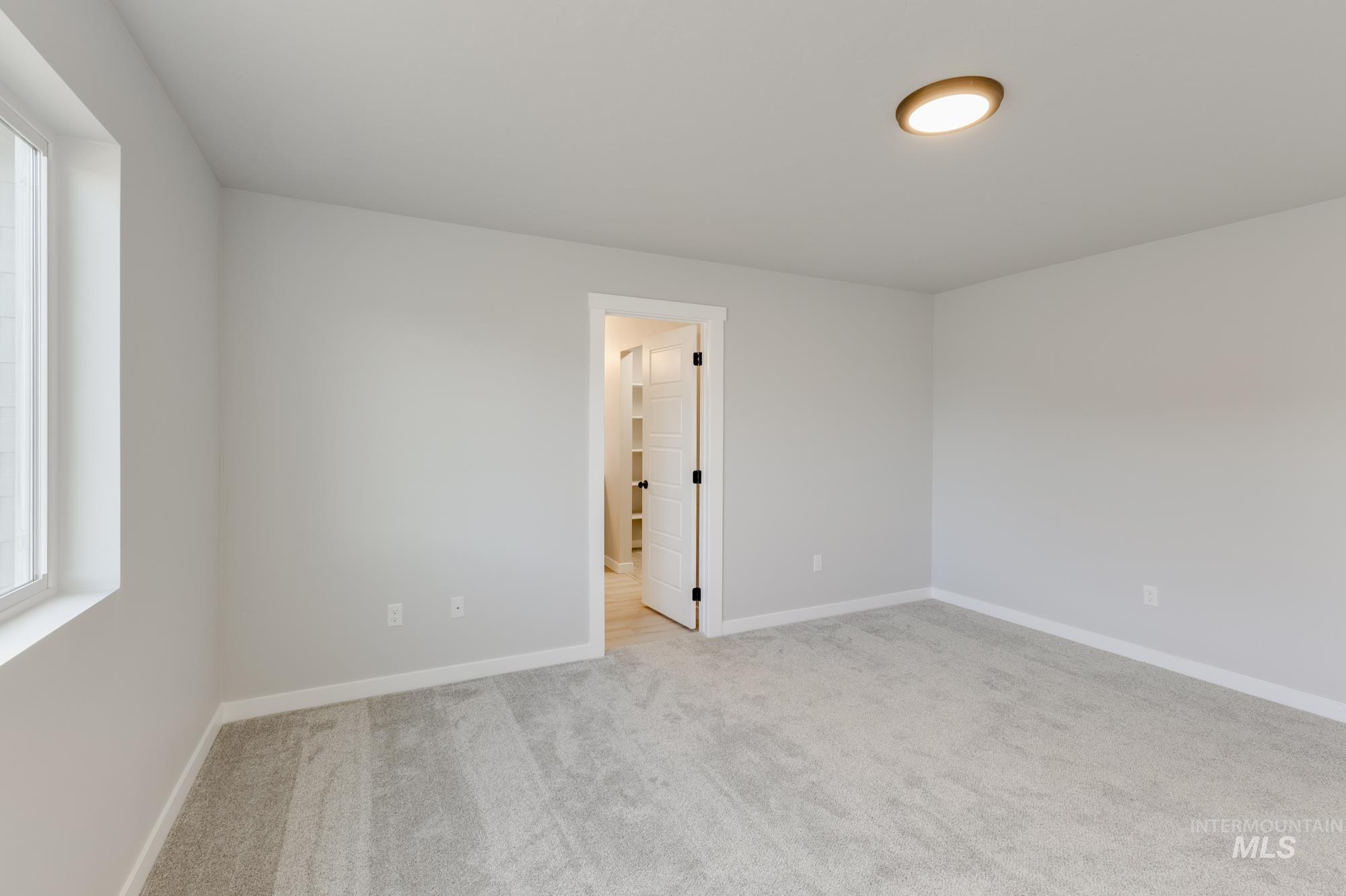 Unfurnished room featuring healthy amount of natural light and light colored carpet