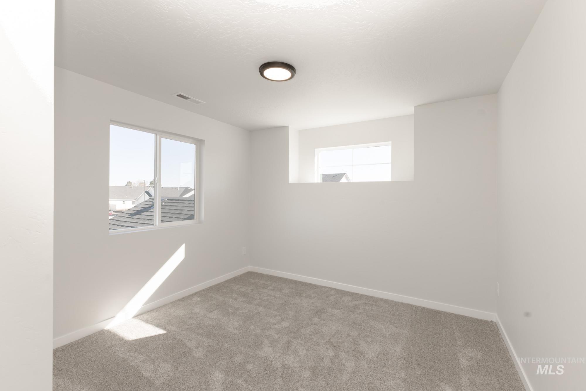 Unfurnished room with light carpet and baseboards