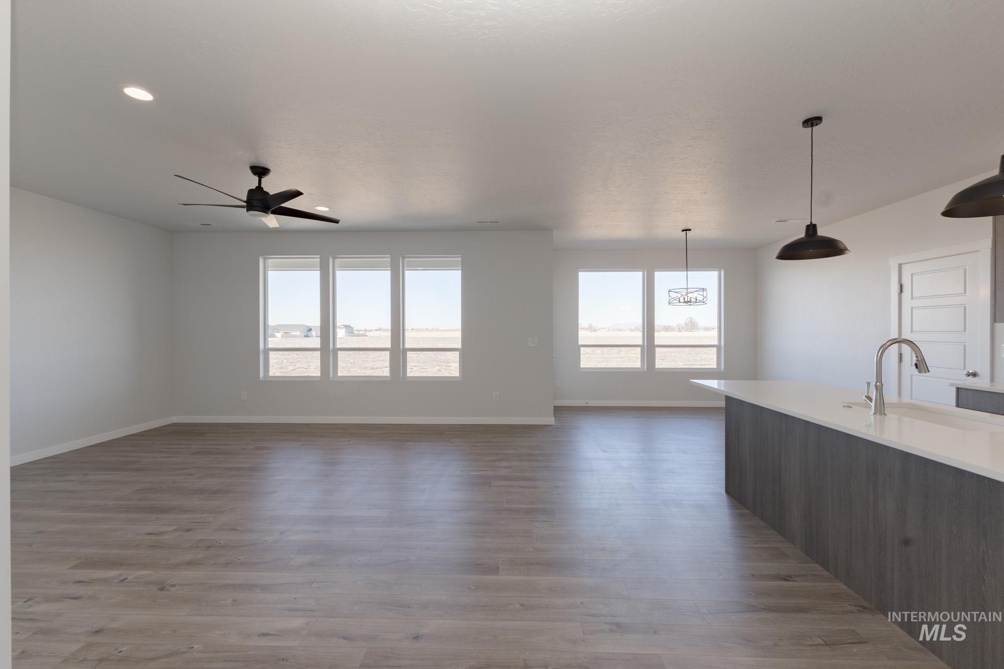 Kitchen with light wood-style floors, decorative light fixtures, open floor plan, and recessed lighting