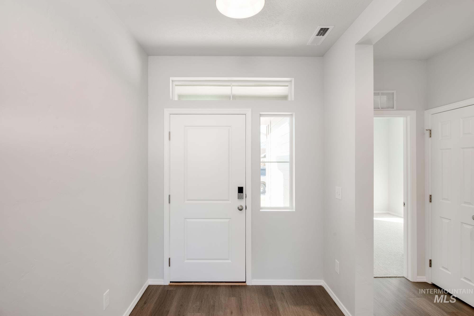 Foyer featuring dark wood-style floors