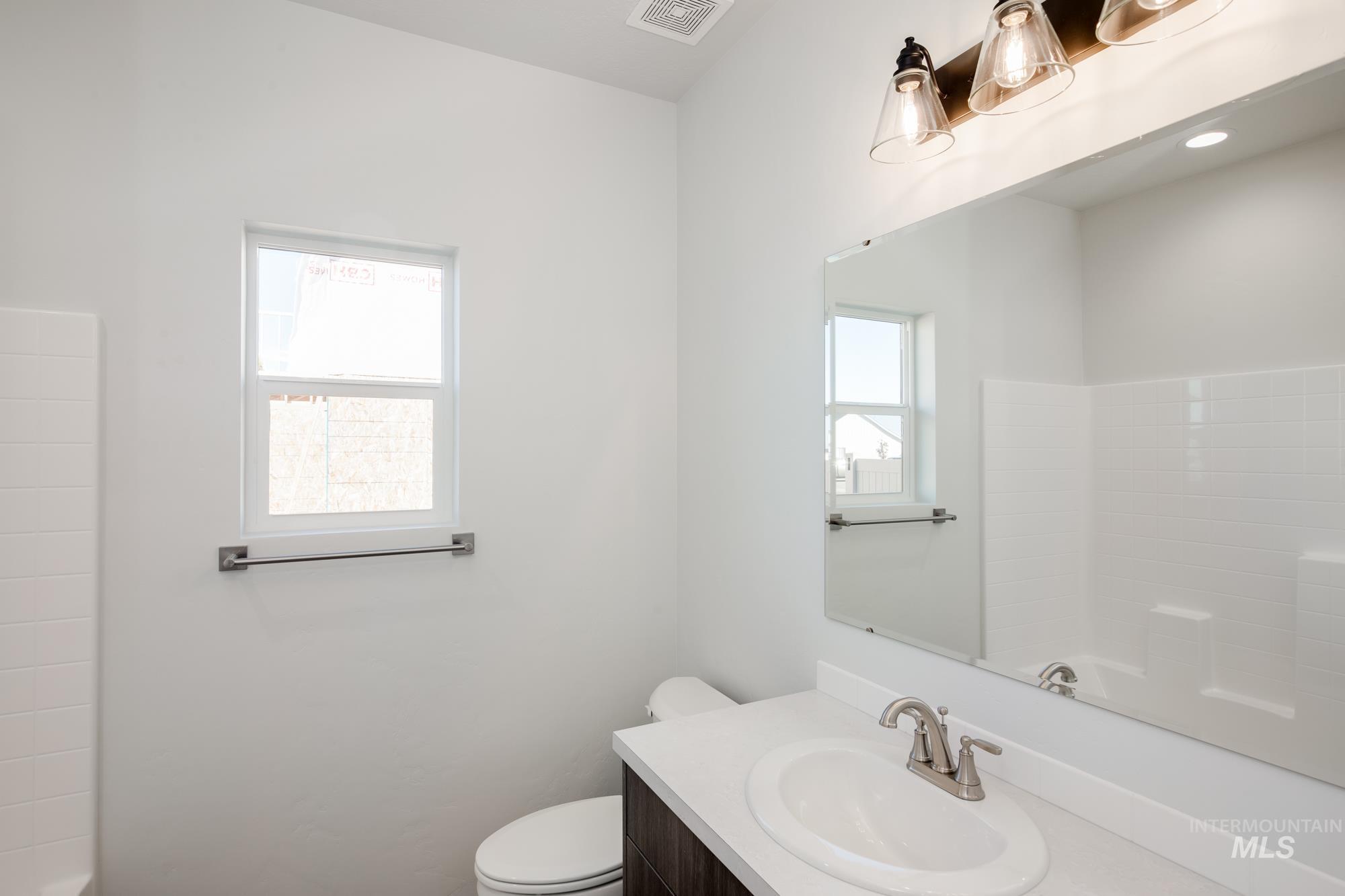 Bathroom featuring vanity and shower / tub combination