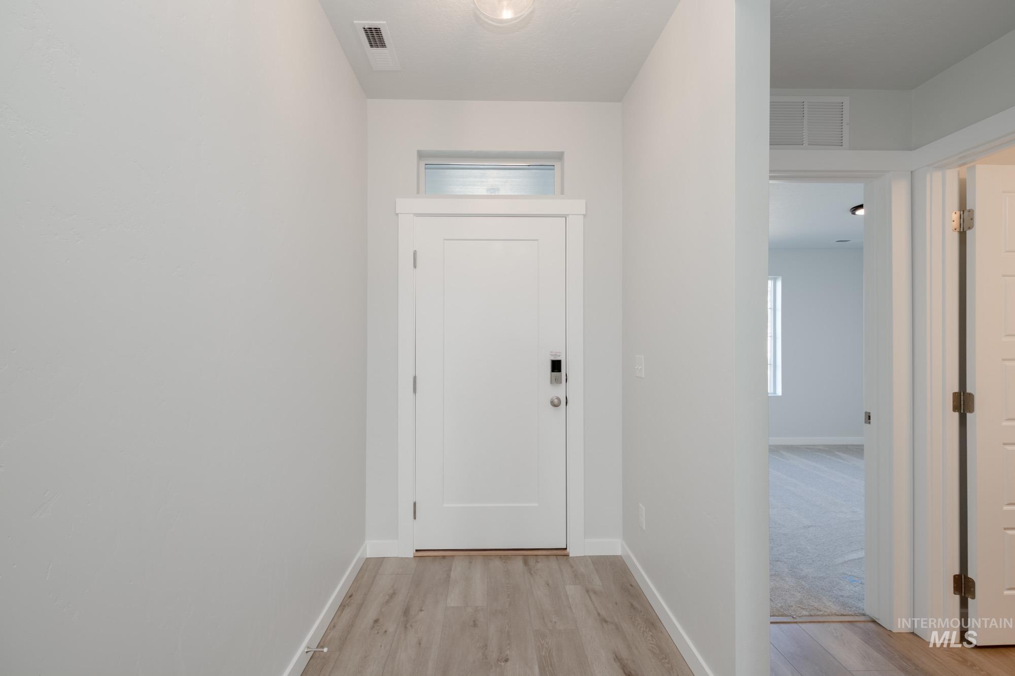 Entryway with wood finished floors