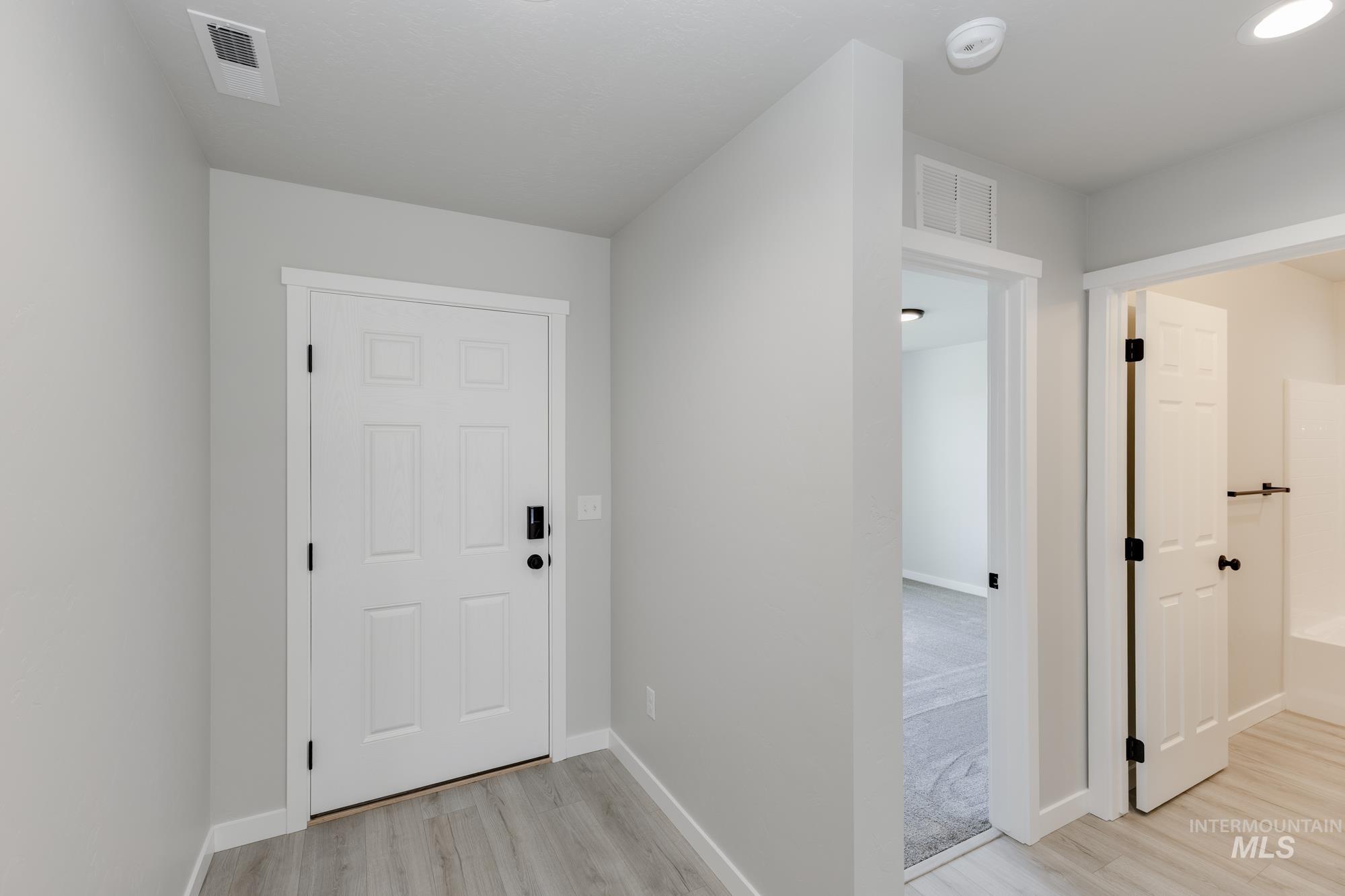 Entryway featuring light wood finished floors and baseboards