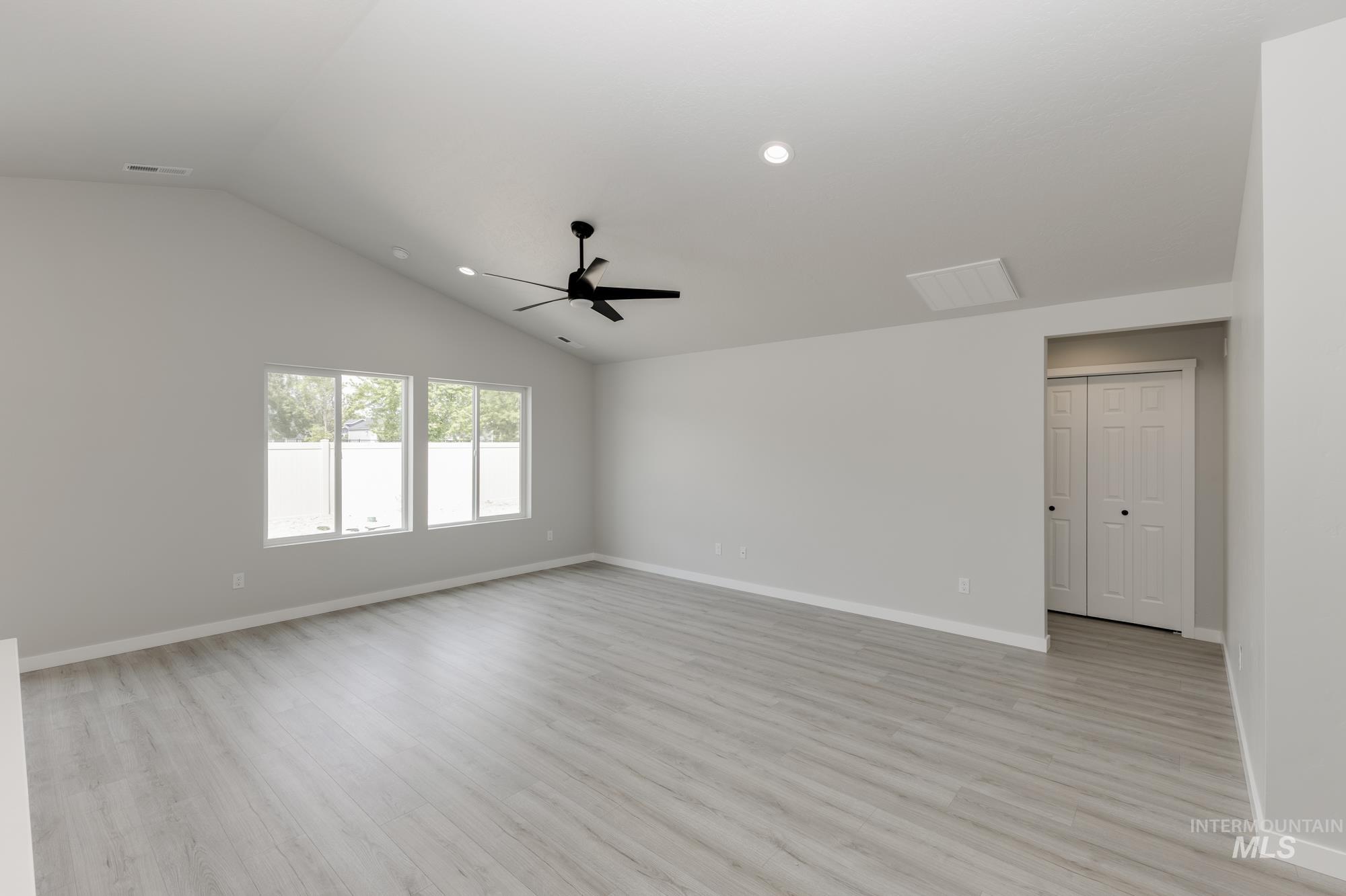 Unfurnished room featuring light wood-style flooring, lofted ceiling, recessed lighting, and ceiling fan