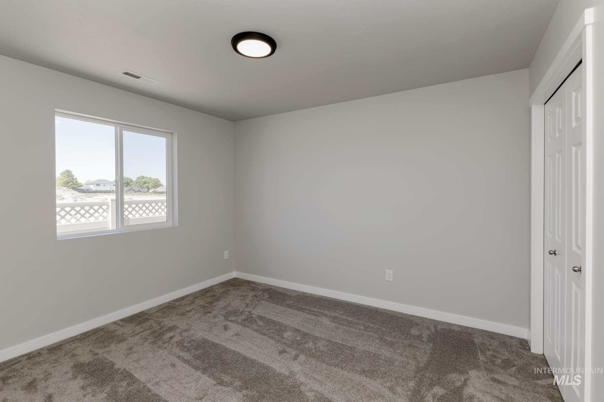 Unfurnished bedroom featuring carpet flooring and a closet