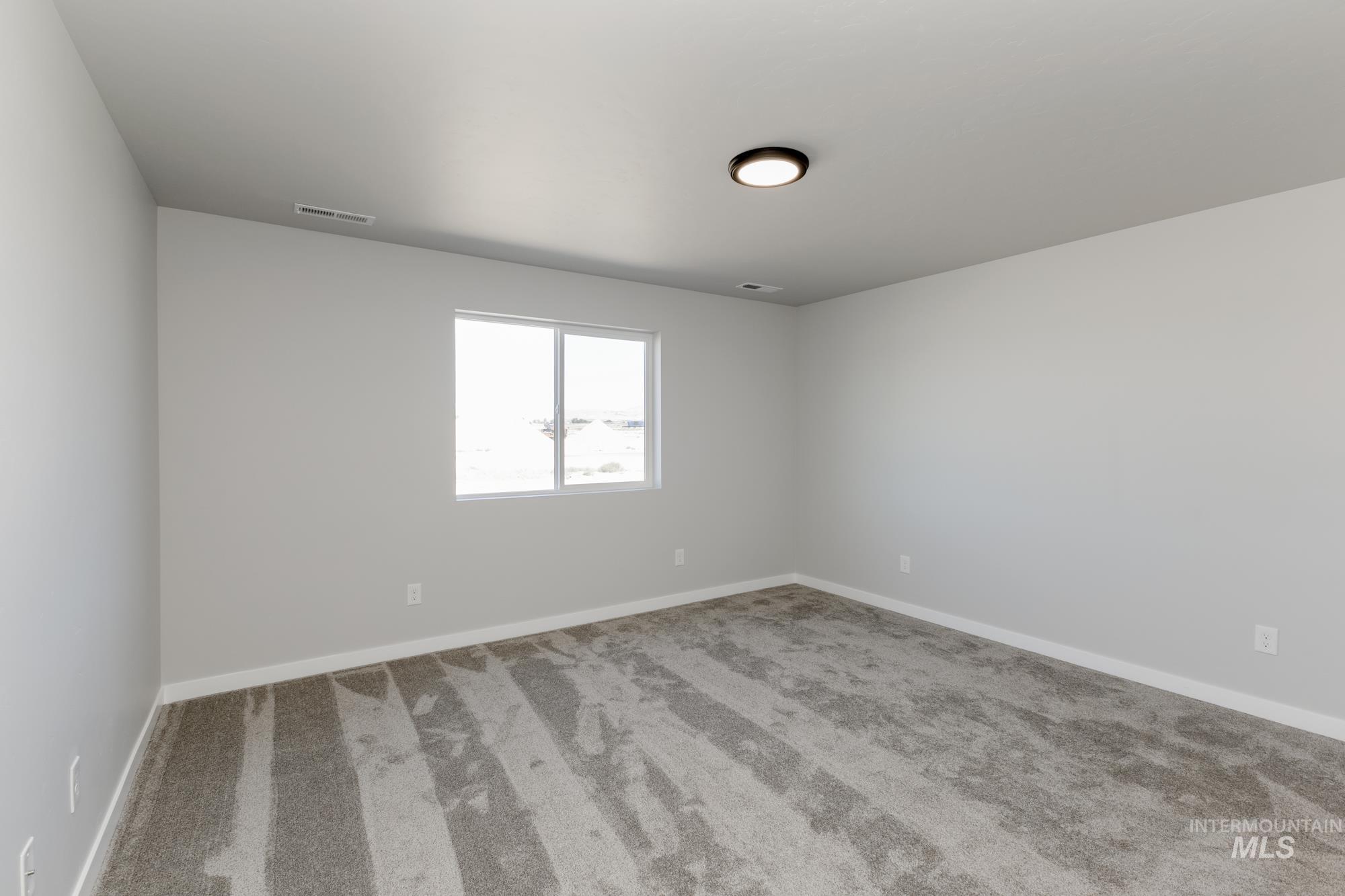 Unfurnished room with carpet flooring and baseboards
