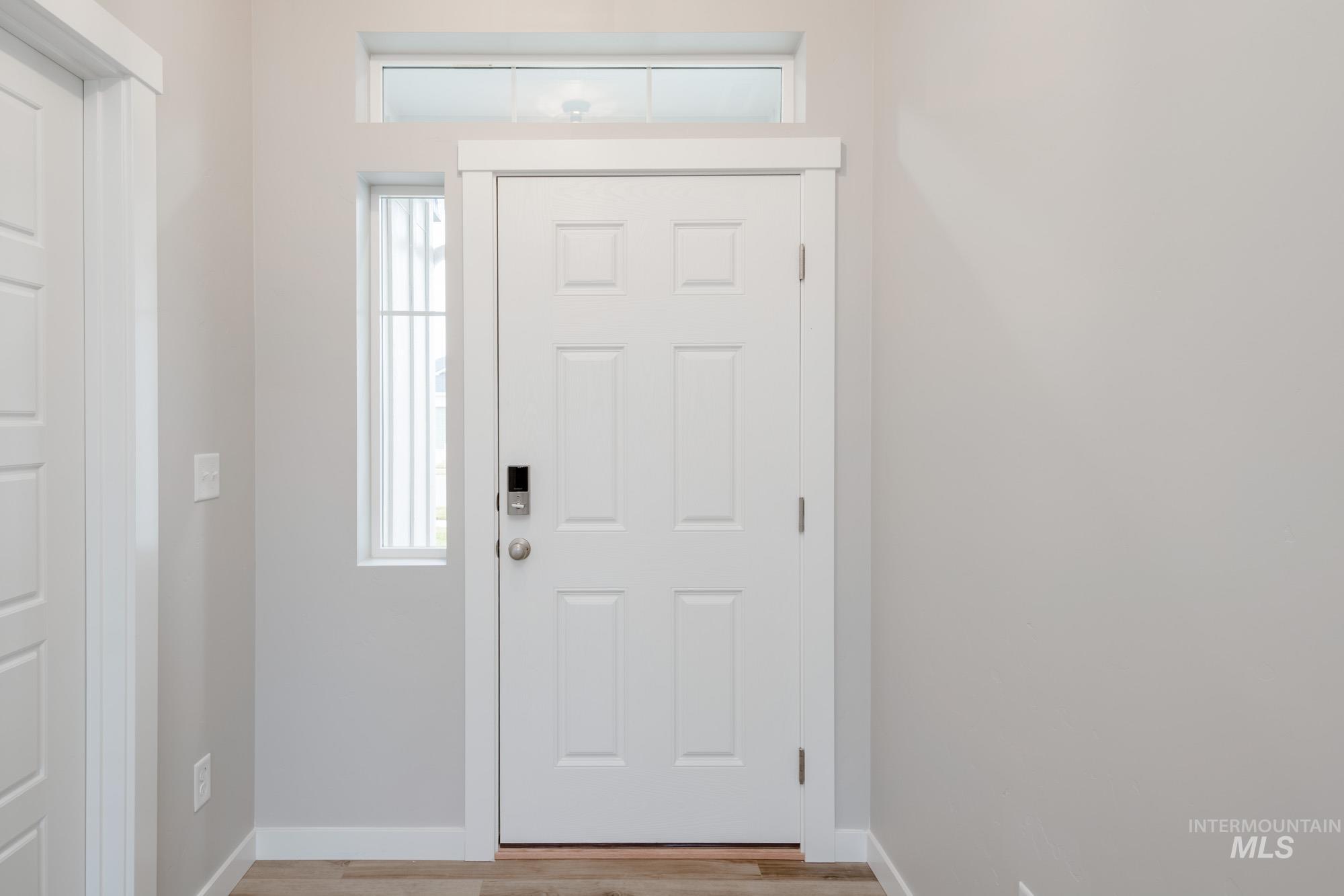Foyer entrance with healthy amount of natural light and light wood-type flooring