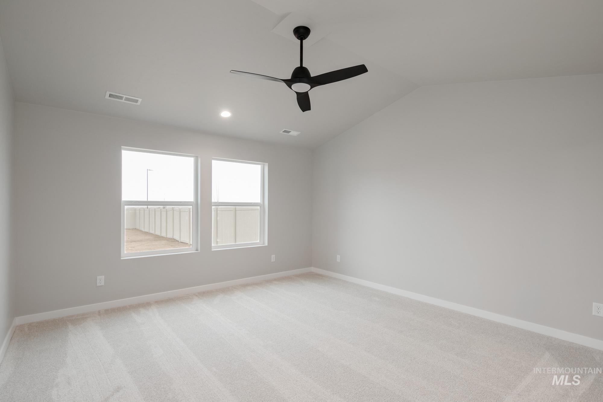 Unfurnished room with light carpet, lofted ceiling, a ceiling fan, and recessed lighting