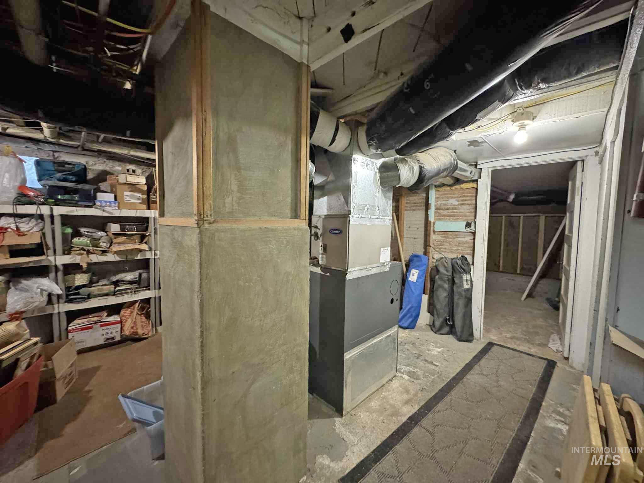 Unfinished basement featuring heating unit