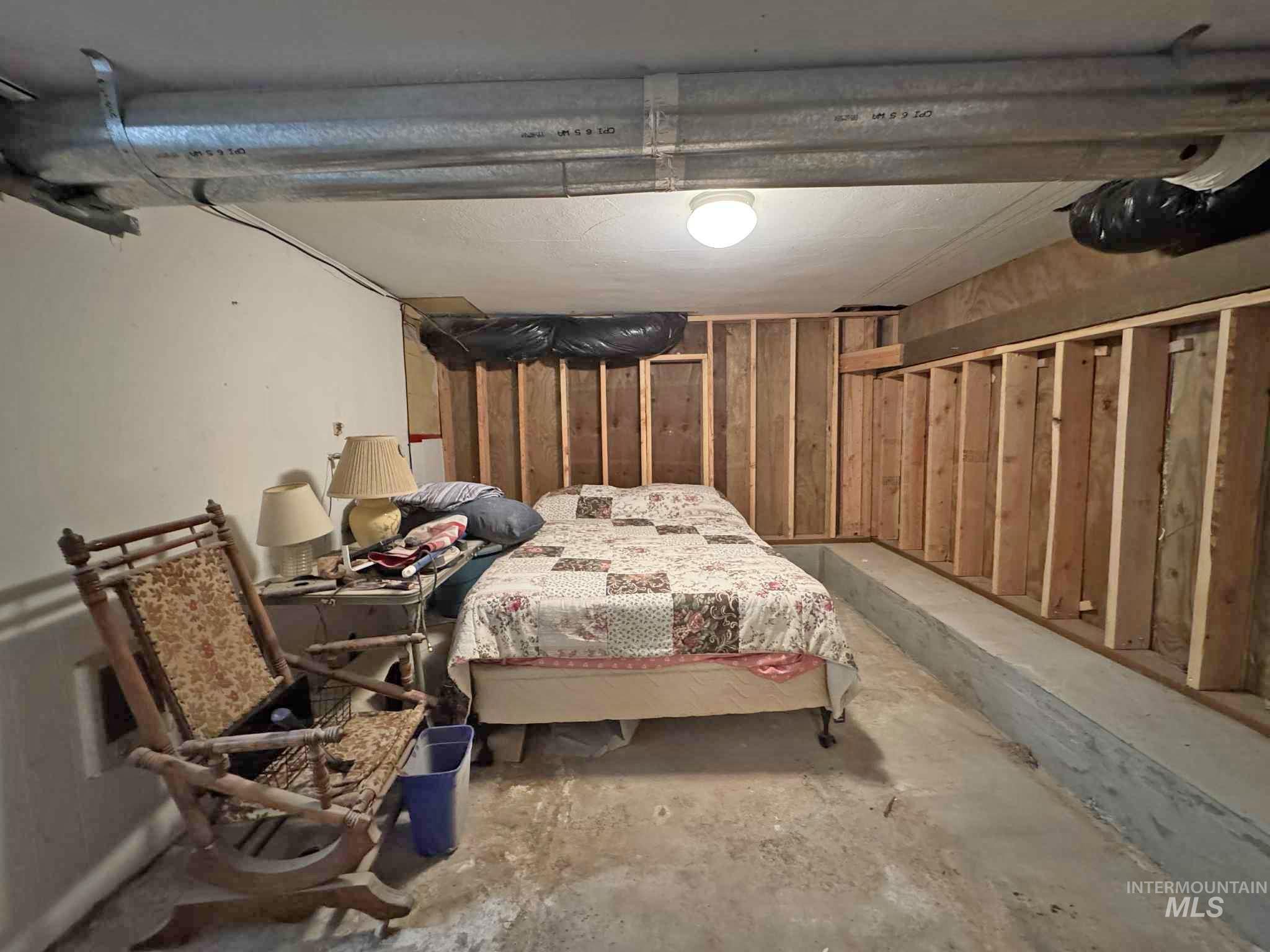 Bedroom featuring unfinished concrete floors