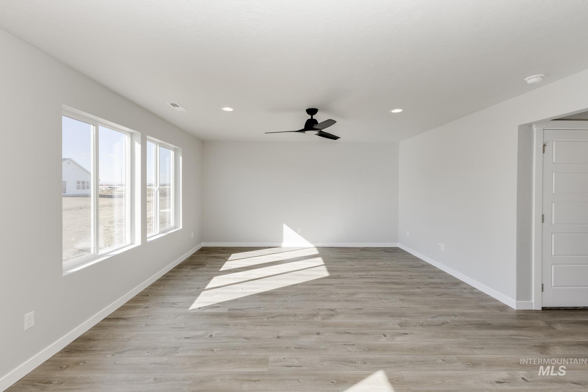 Unfurnished room featuring light wood finished floors, recessed lighting, and a ceiling fan