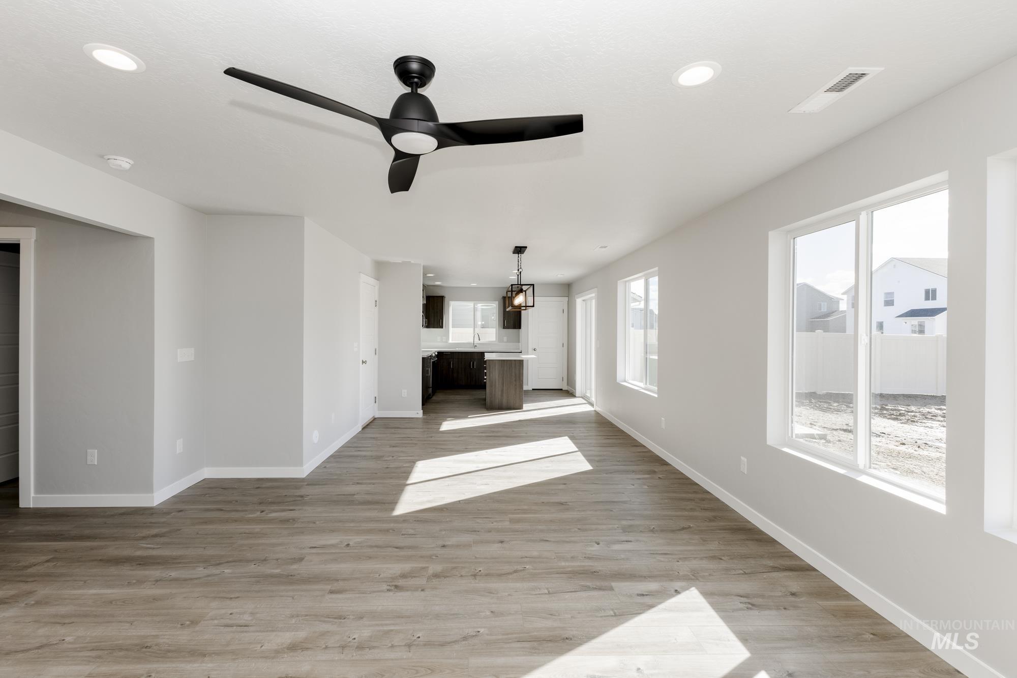 Unfurnished living room featuring light wood-style floors, recessed lighting, and a ceiling fan