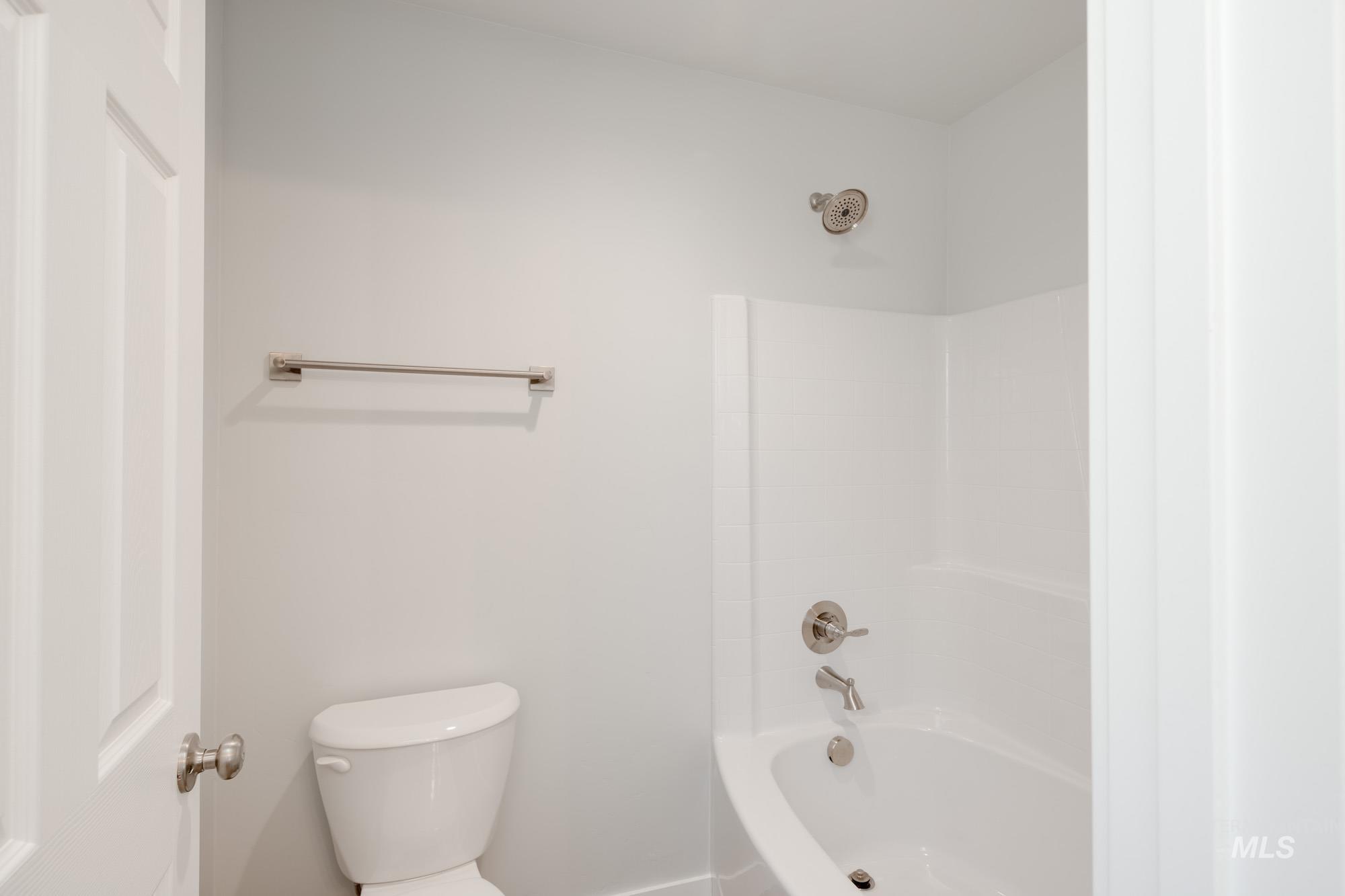 Bathroom featuring shower / bath combination and toilet