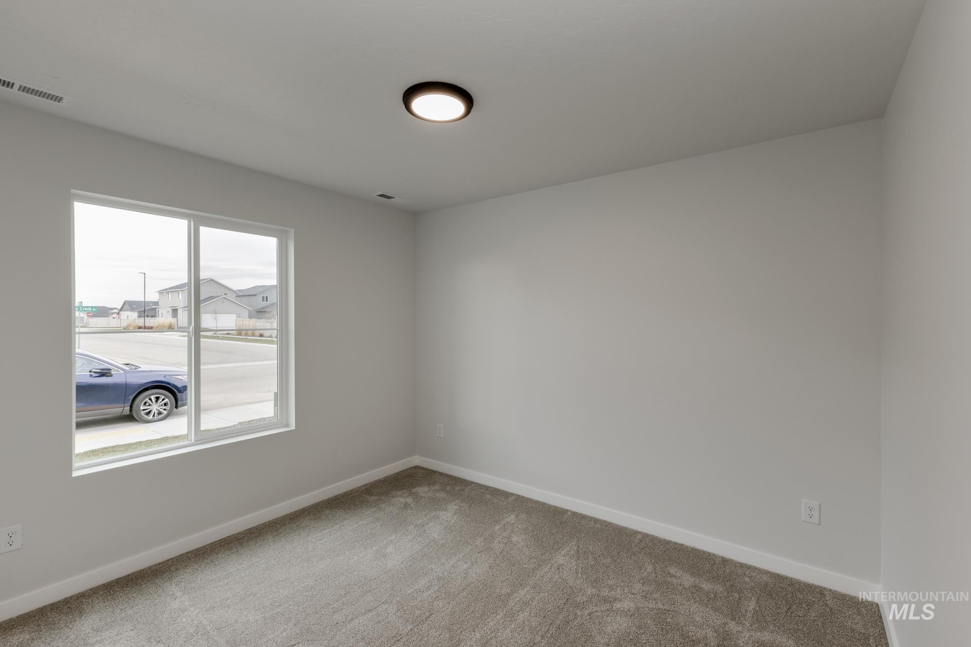 Empty room with carpet flooring and baseboards