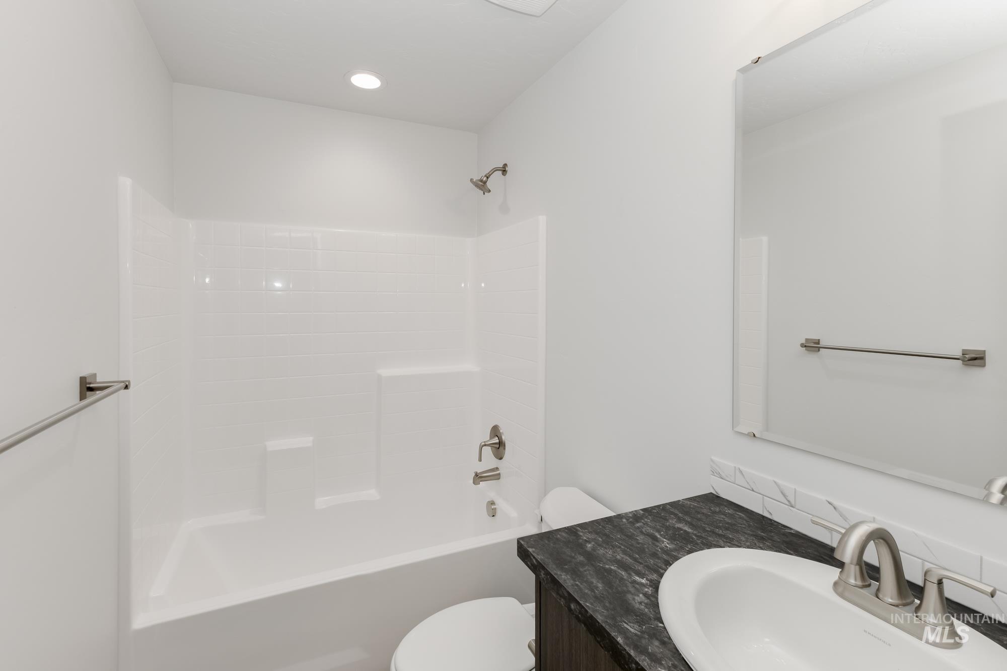 Bathroom featuring bathtub / shower combination and vanity