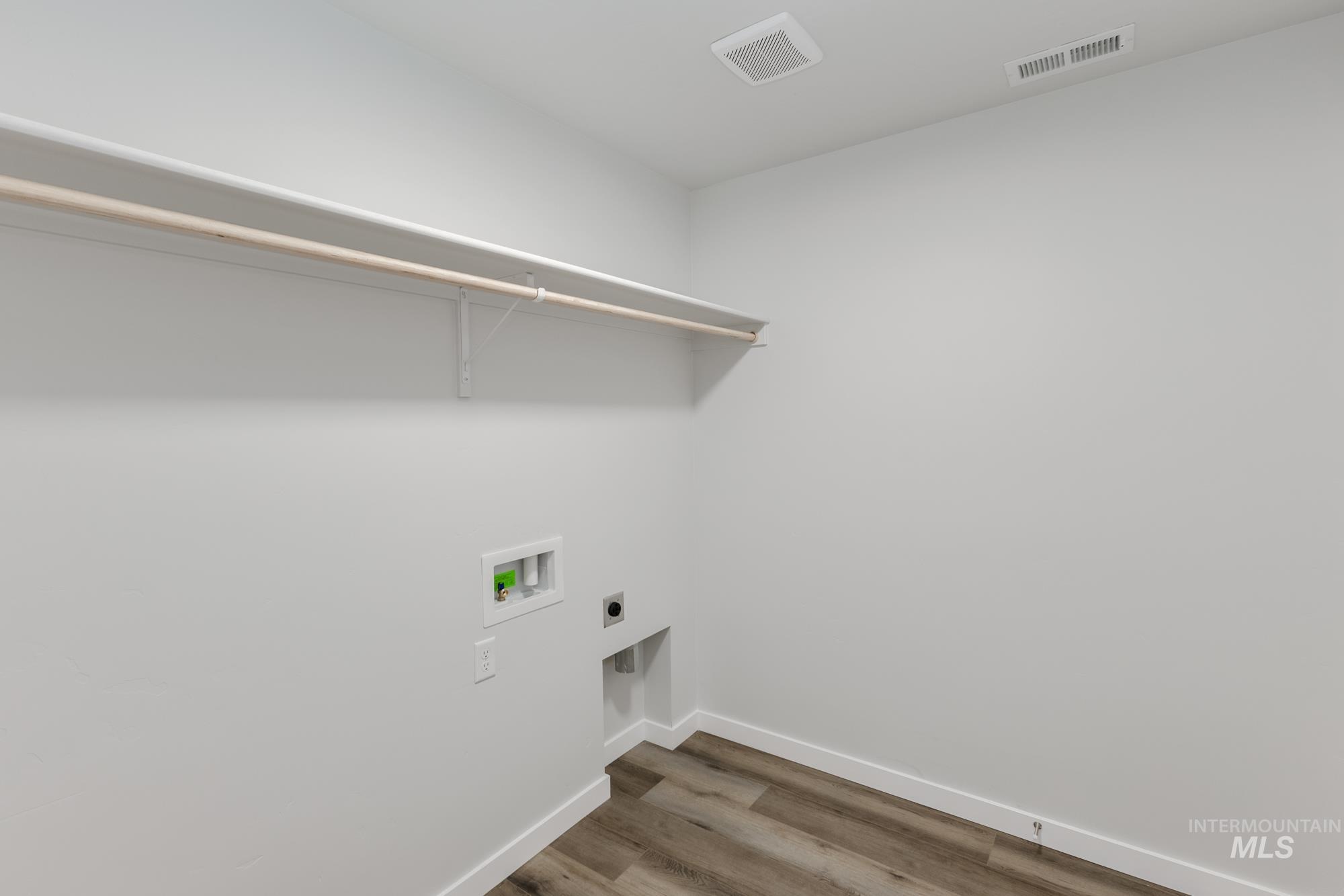 Washroom with wood finished floors, electric dryer hookup, and washer hookup