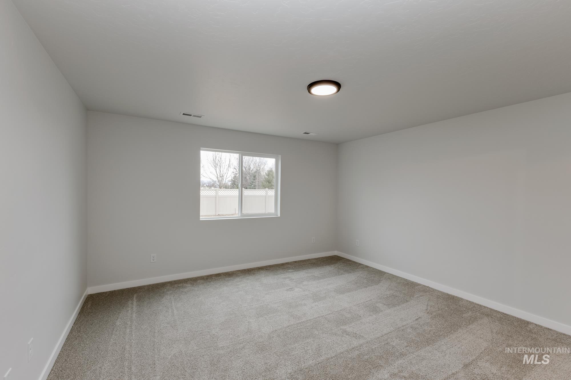 Unfurnished room with light carpet and baseboards