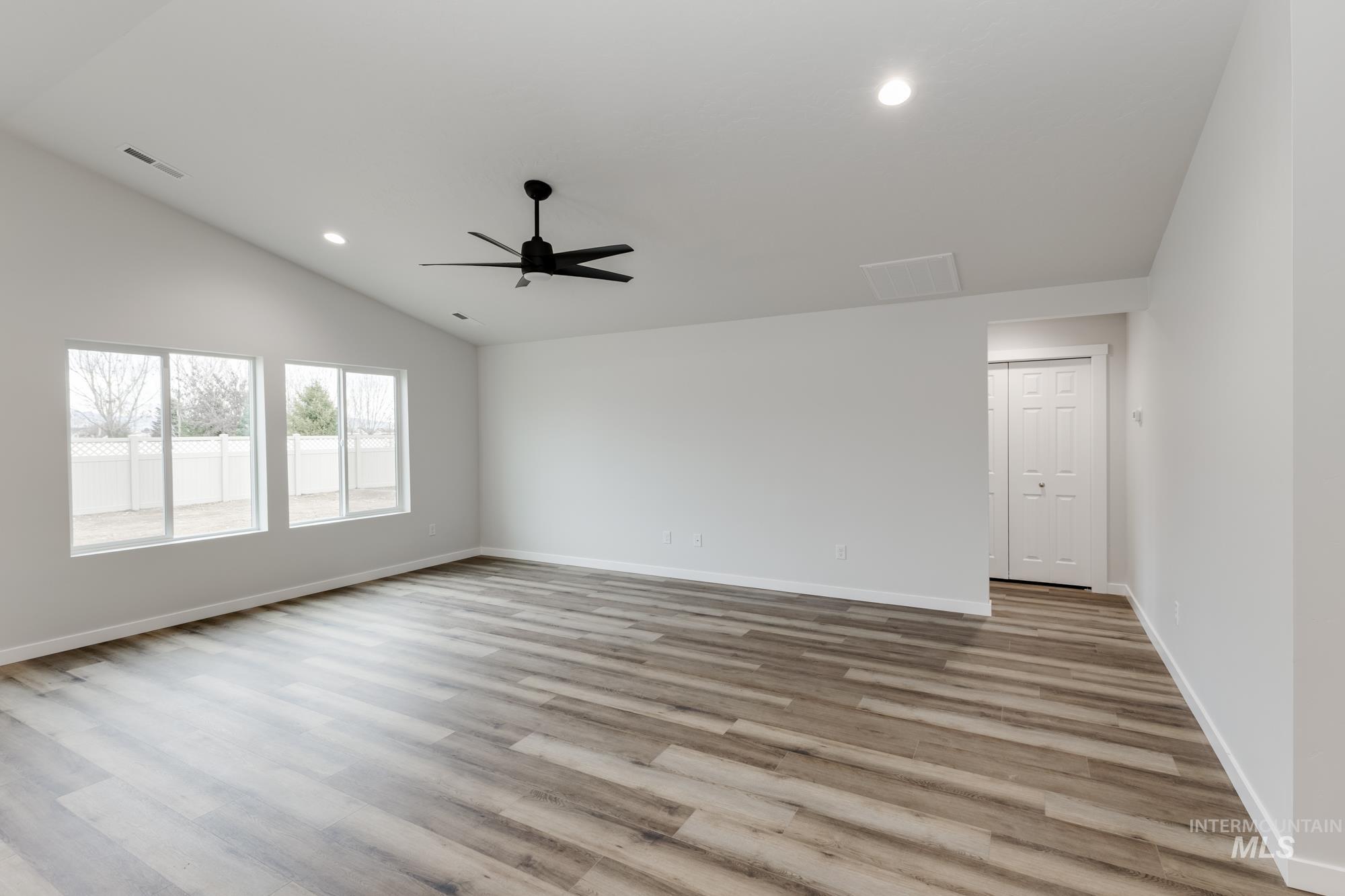 Unfurnished room with recessed lighting, vaulted ceiling, light wood-type flooring, and a ceiling fan