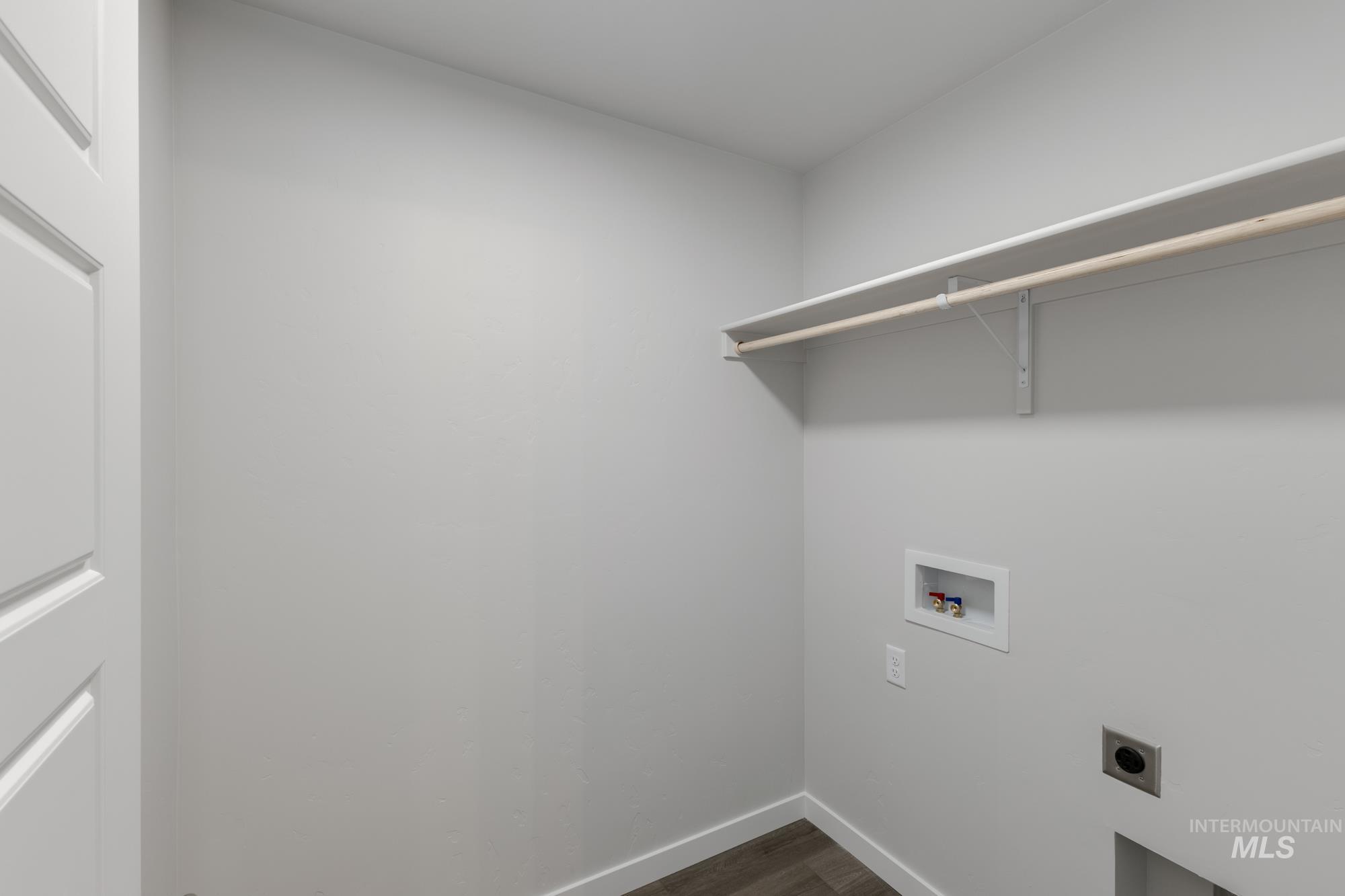 Washroom featuring washer hookup, hookup for an electric dryer, and dark wood finished floors