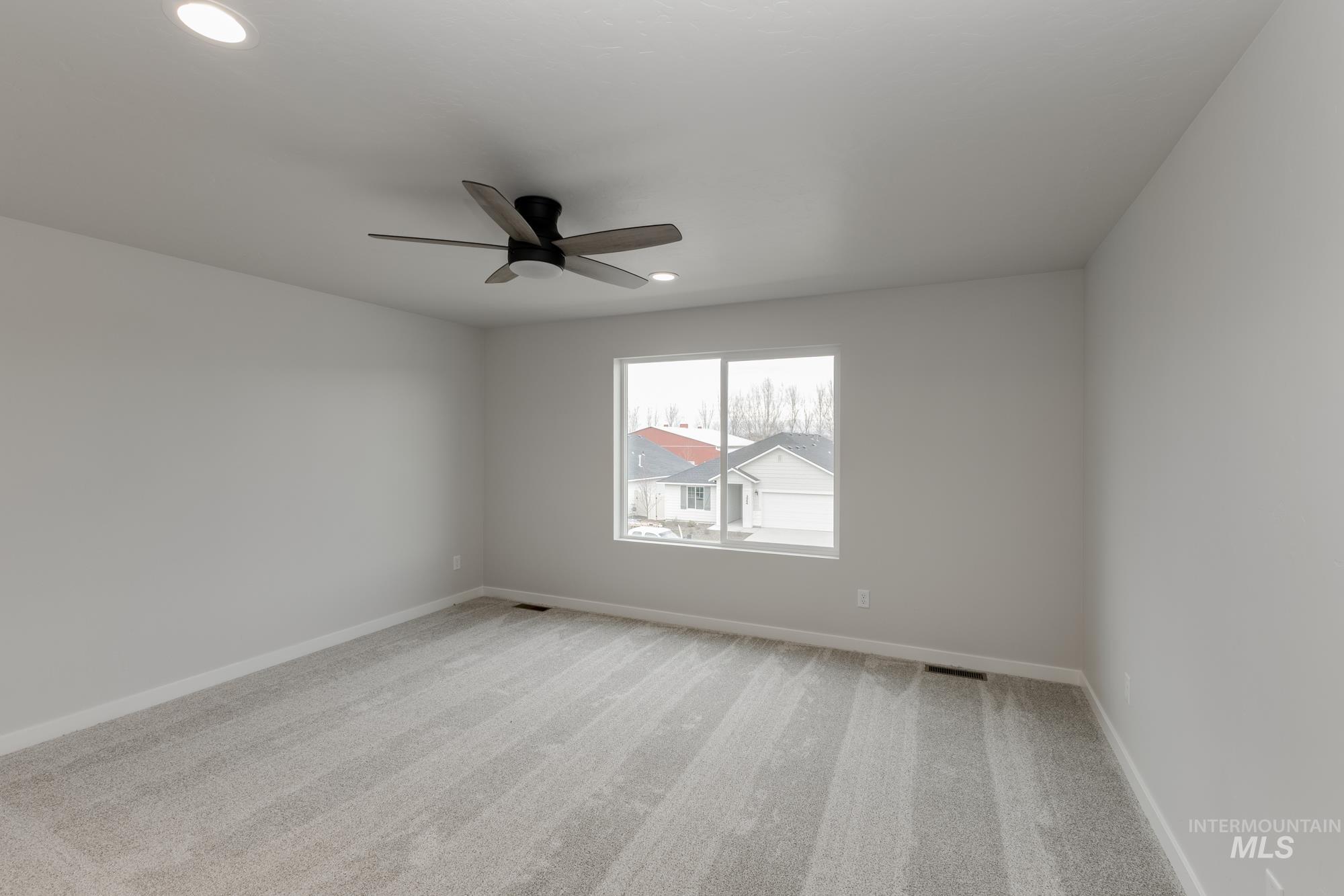Spare room with light carpet, recessed lighting, and a ceiling fan