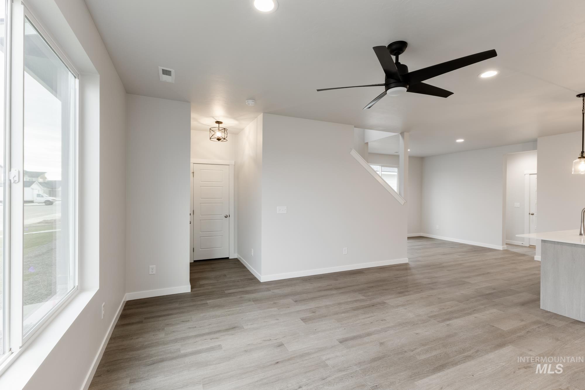 Empty room with recessed lighting, light wood-style flooring, and a ceiling fan