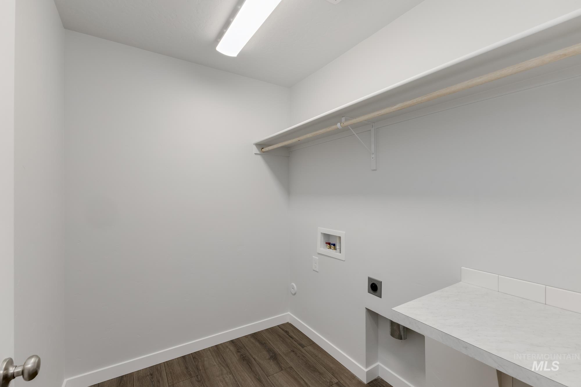 Laundry area featuring hookup for an electric dryer, dark wood-style floors, and hookup for a washing machine