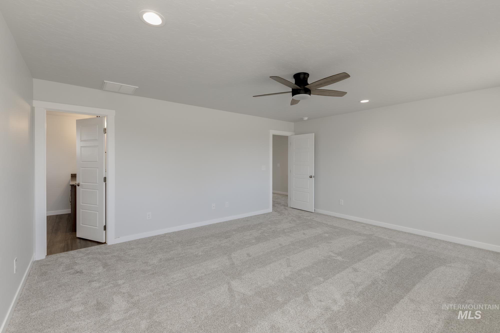 Unfurnished bedroom featuring carpet, recessed lighting, and a ceiling fan