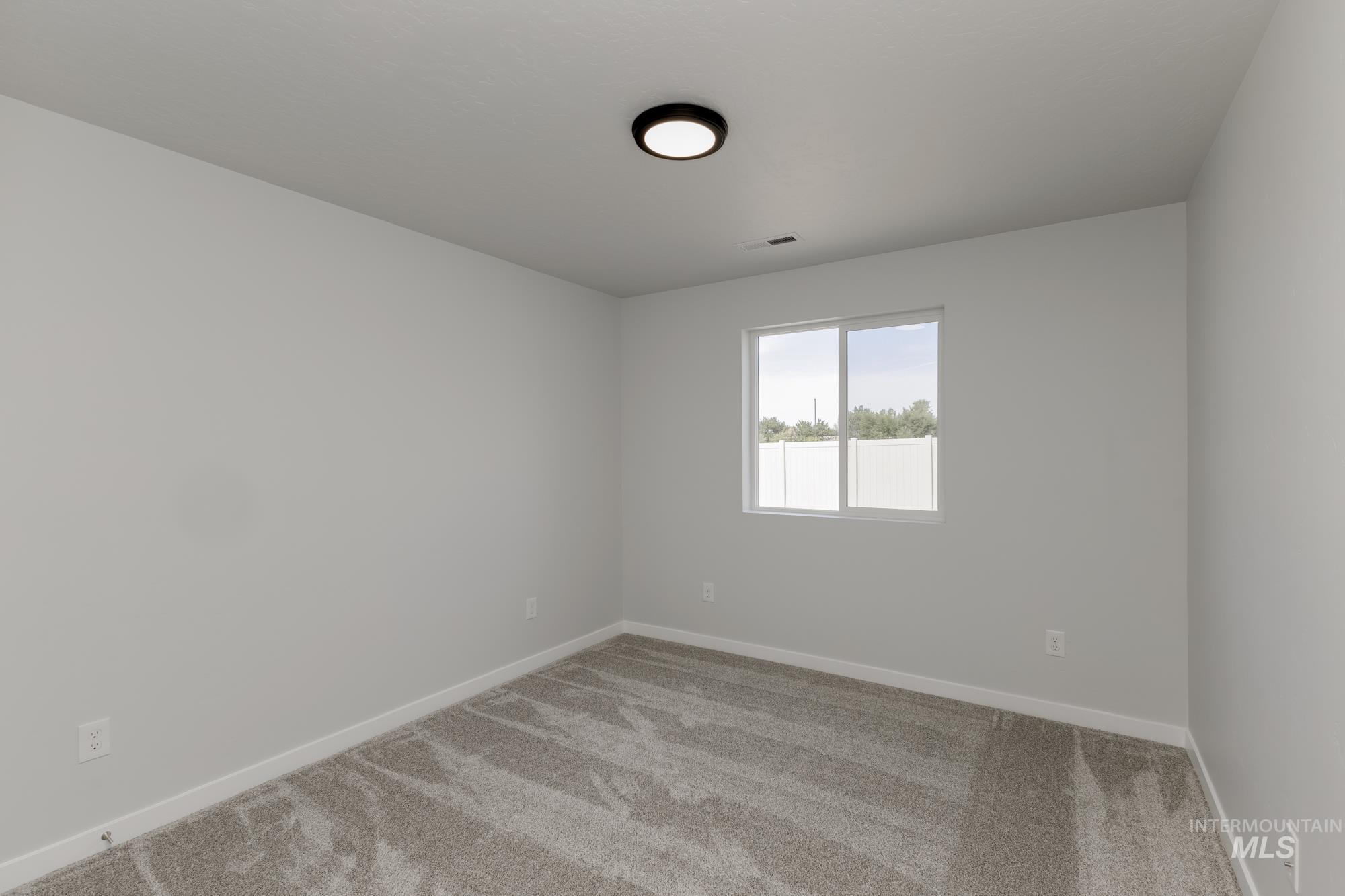 Unfurnished room featuring carpet and baseboards