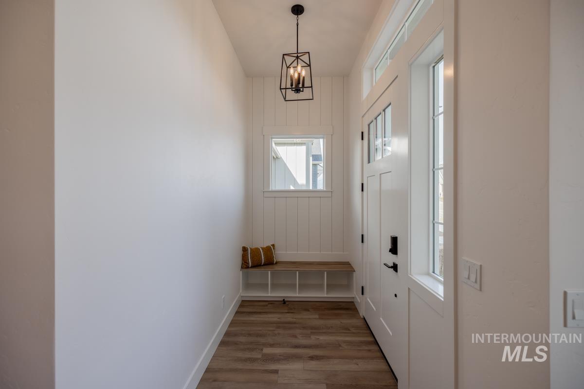 Mudroom featuring light wood-style floors and wooden walls