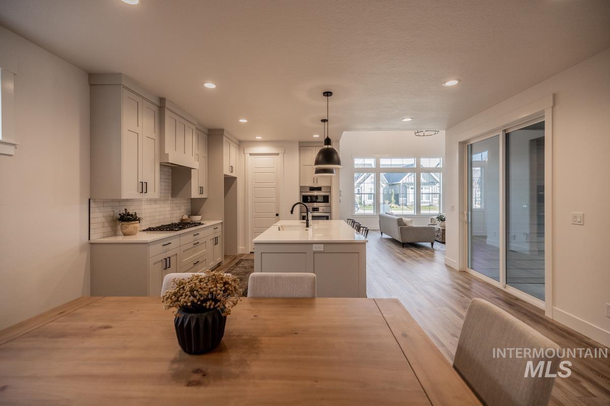 Dining space with recessed lighting and wood finished floors