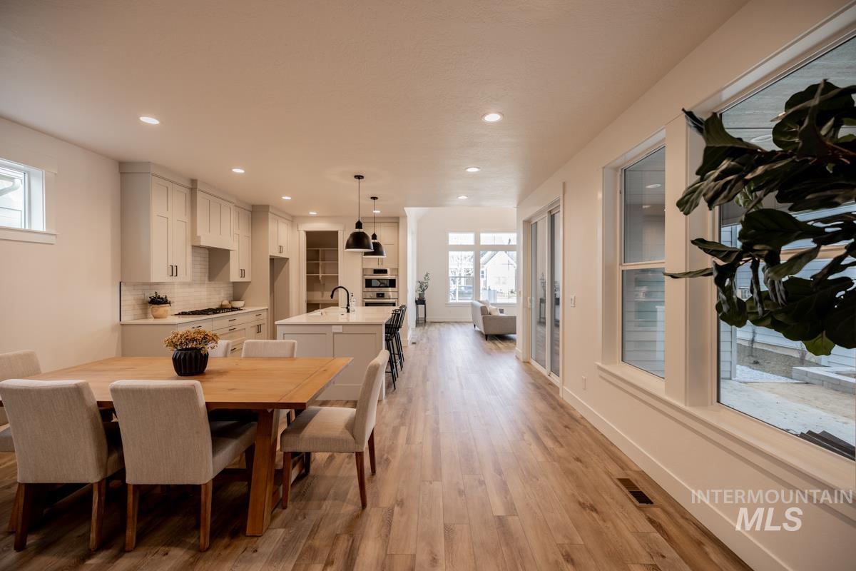 Dining room featuring light wood-type flooring and recessed lighting