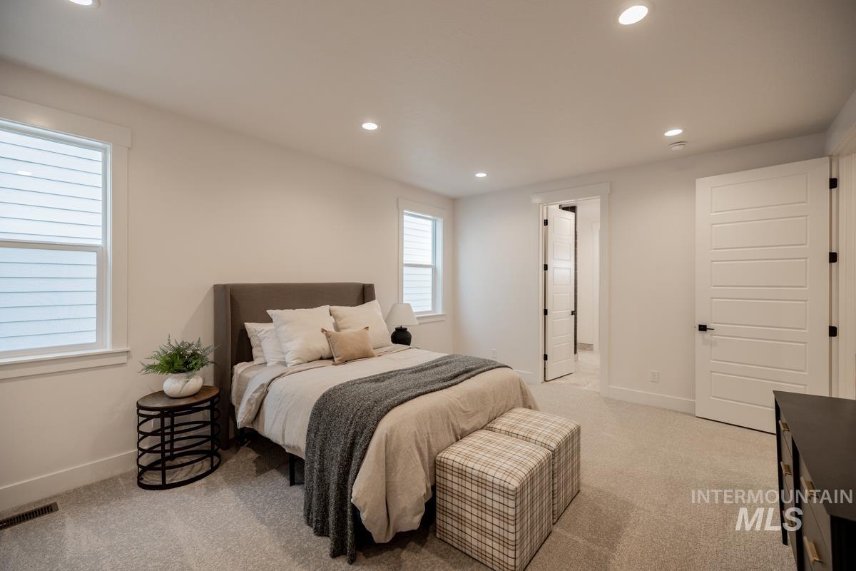 Bedroom featuring recessed lighting and light carpet