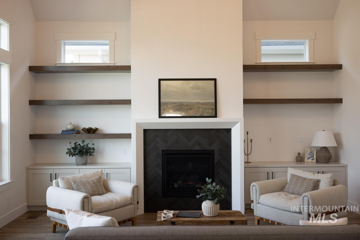 Living room featuring a fireplace, wood finished floors, and healthy amount of natural light