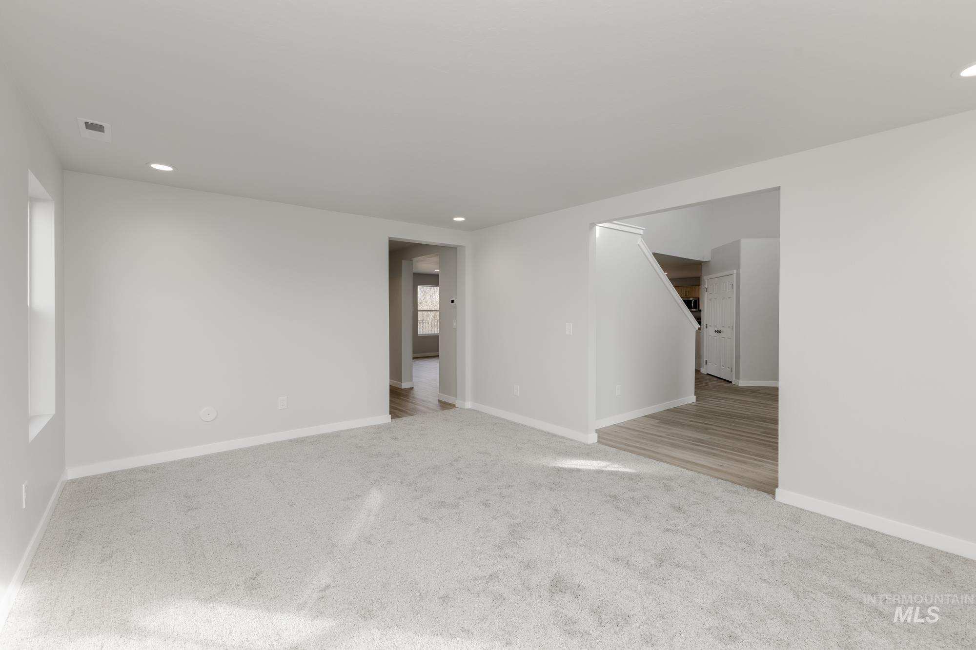 Spare room with light colored carpet and recessed lighting