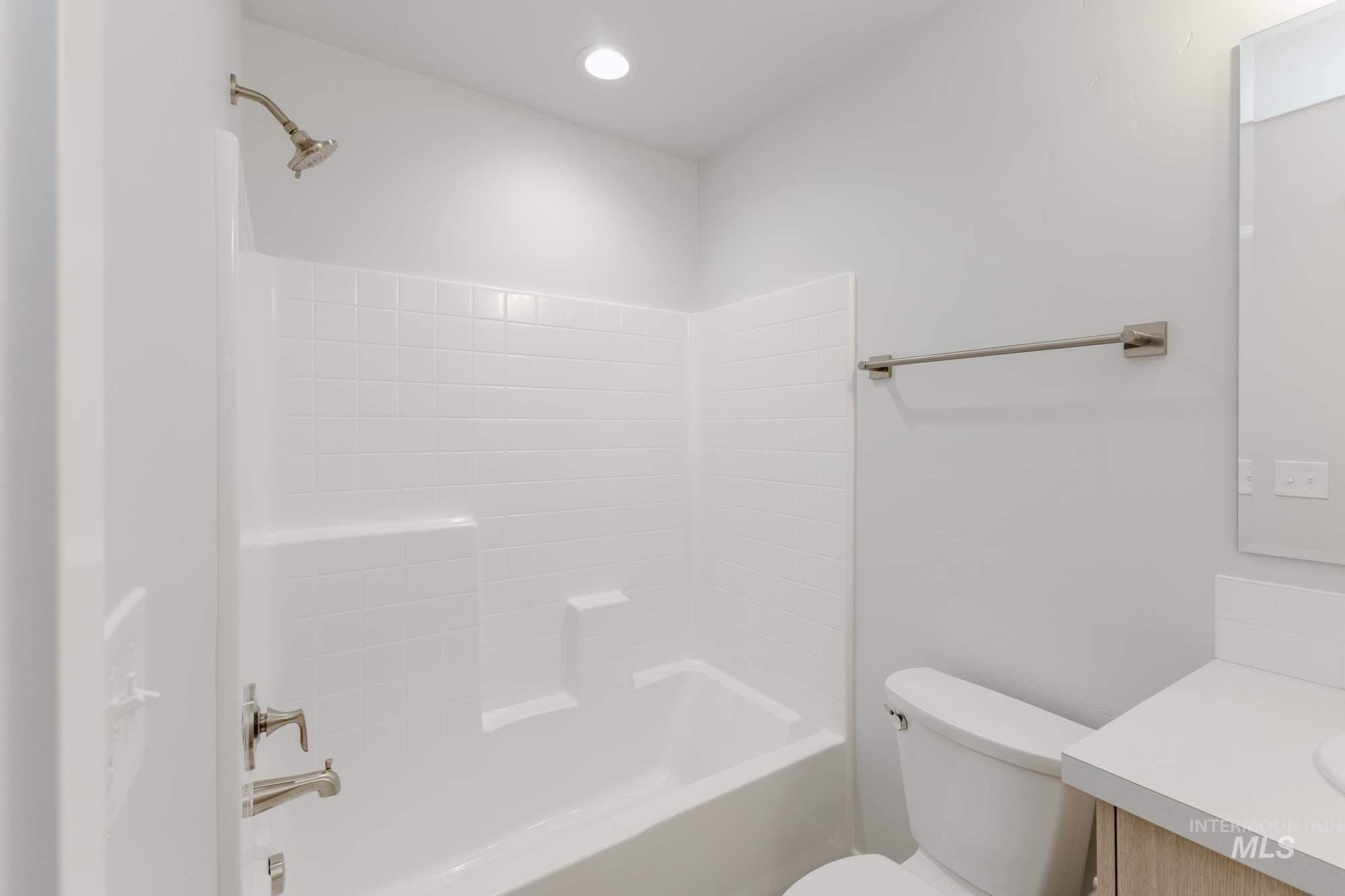 Bathroom featuring vanity, shower / bath combination, and recessed lighting
