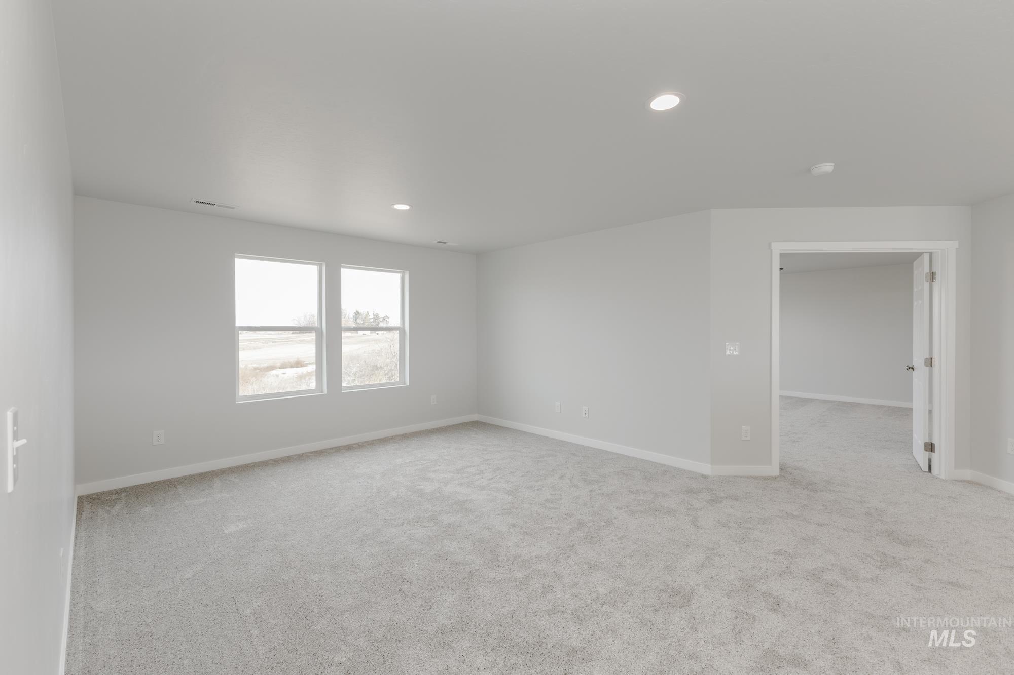 Spare room with light colored carpet and recessed lighting