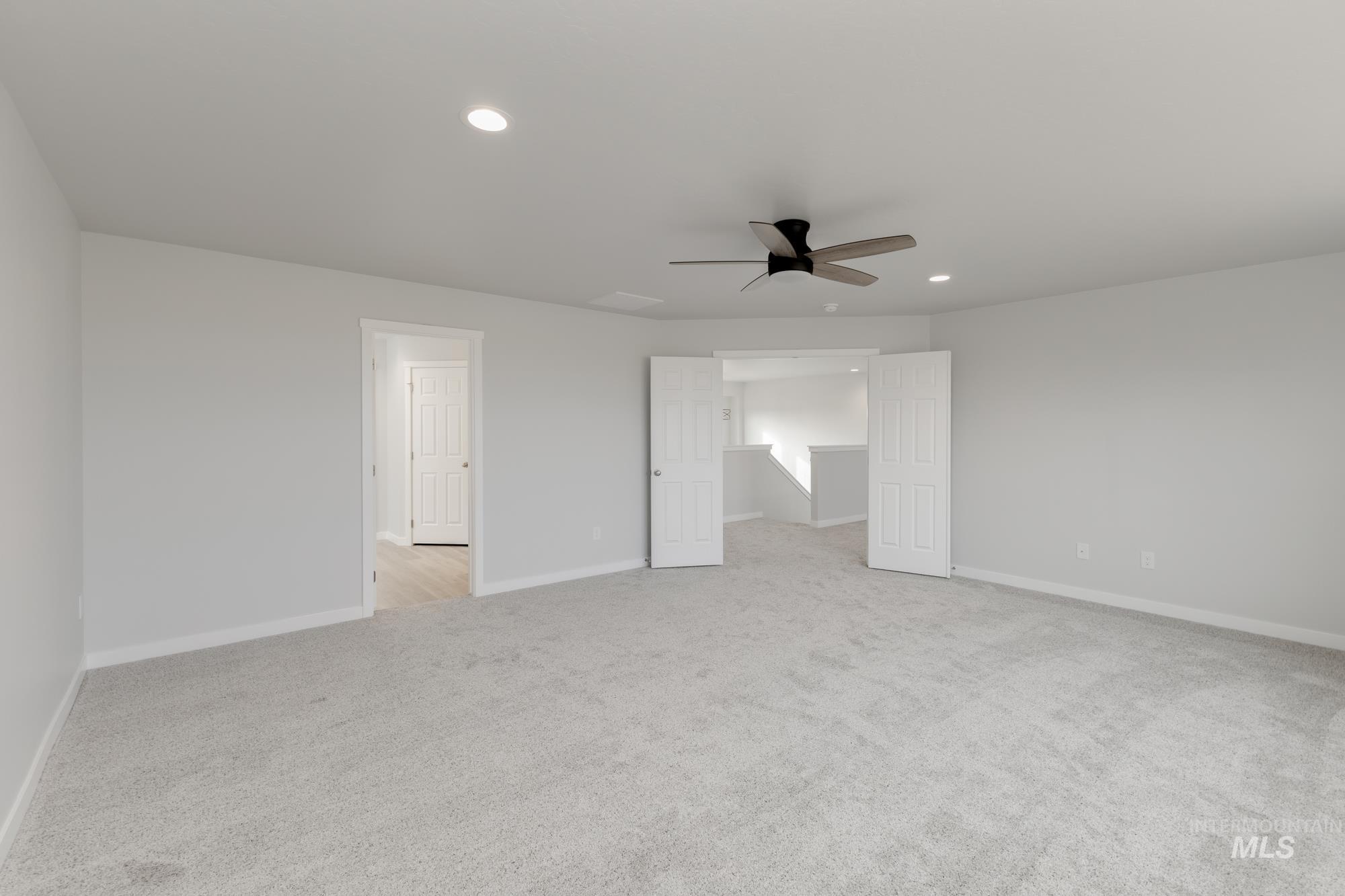 Unfurnished room featuring recessed lighting, light carpet, and ceiling fan