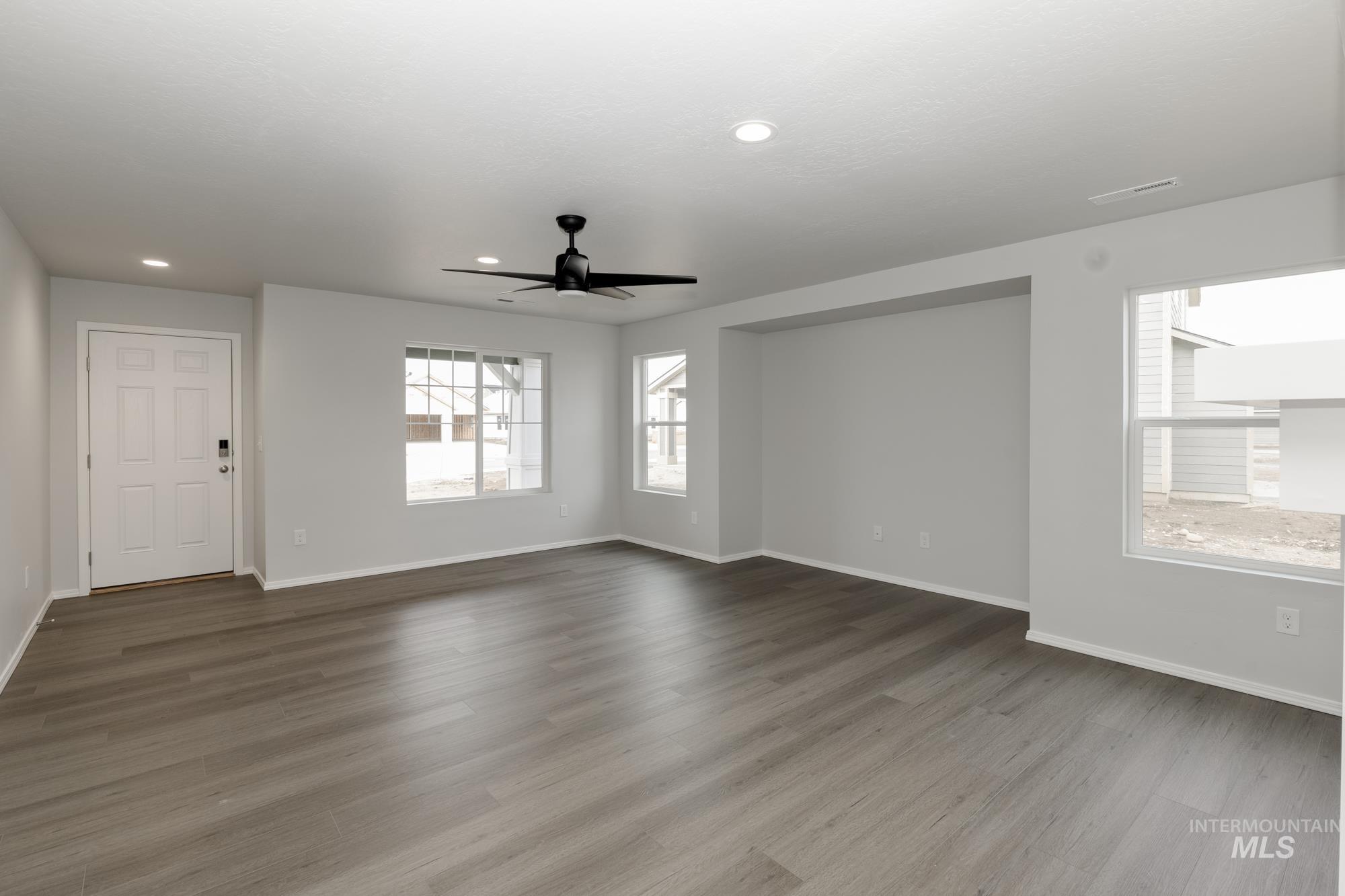 Spare room with ceiling fan, wood finished floors, and recessed lighting