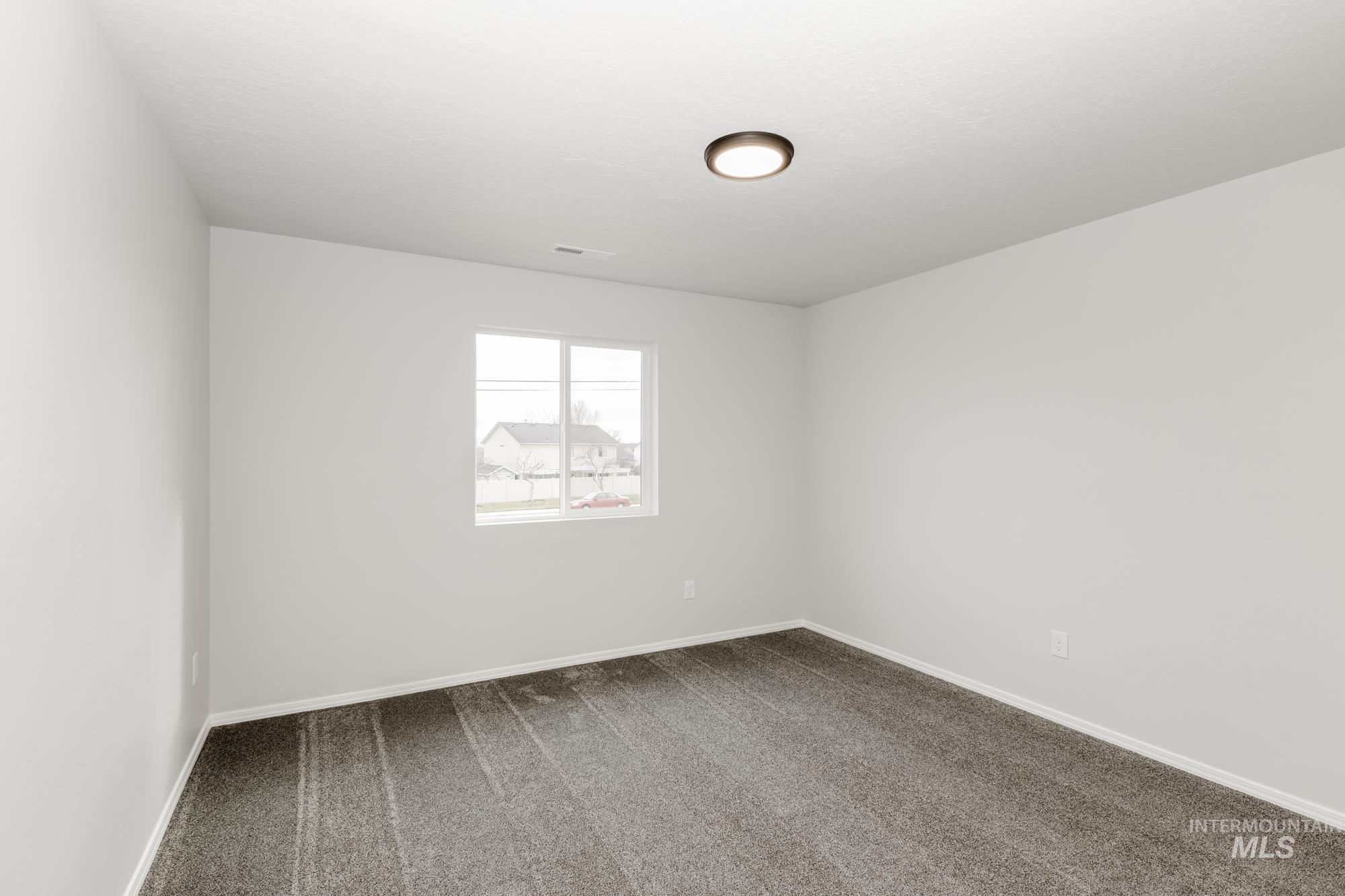 Unfurnished room featuring carpet and baseboards