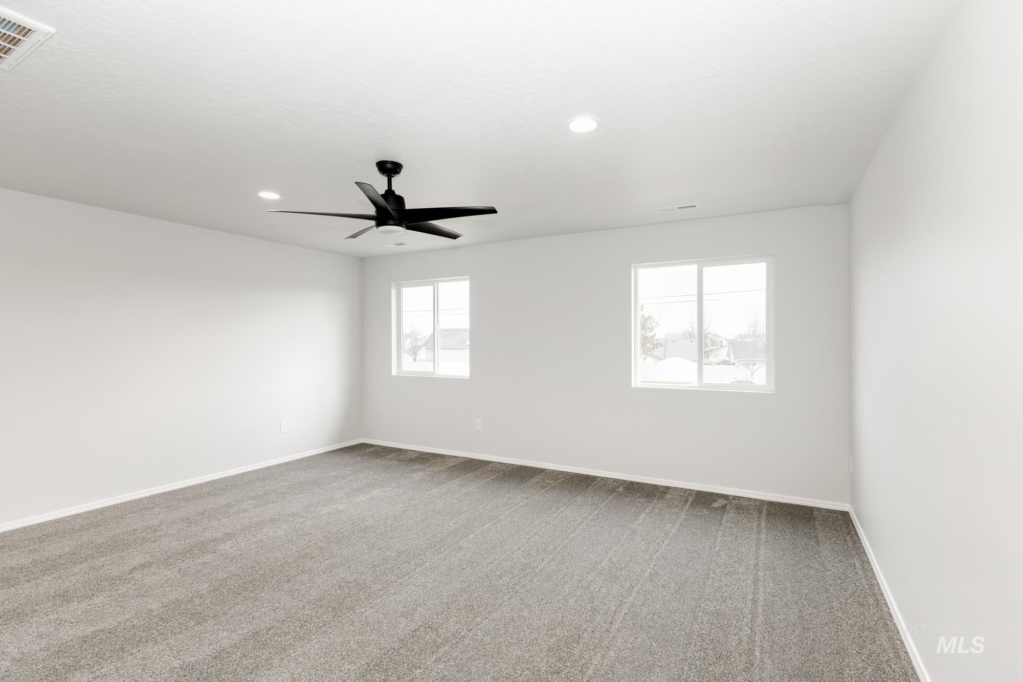 Spare room featuring light colored carpet, recessed lighting, and a ceiling fan