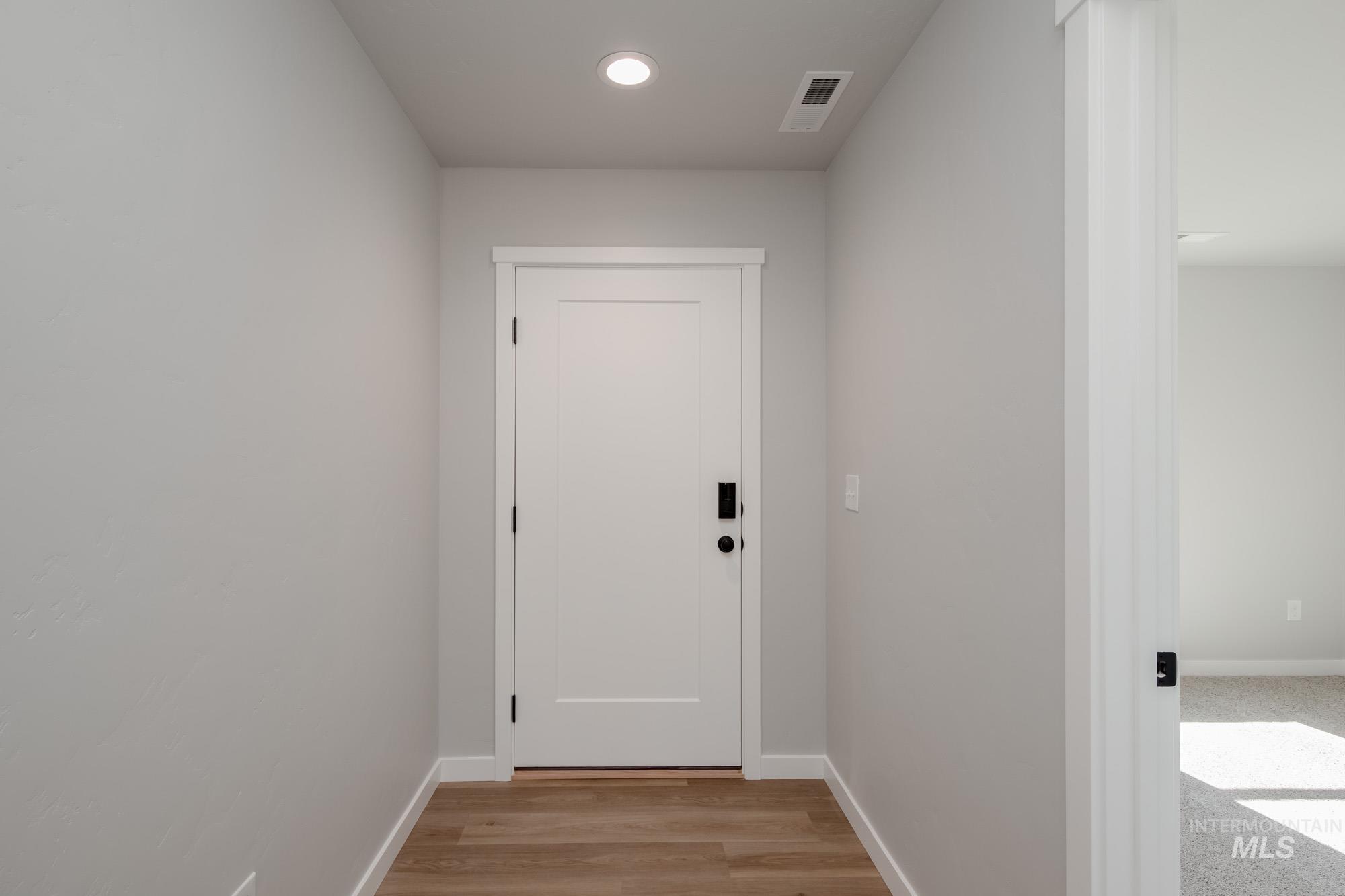 Doorway to outside featuring wood finished floors and recessed lighting
