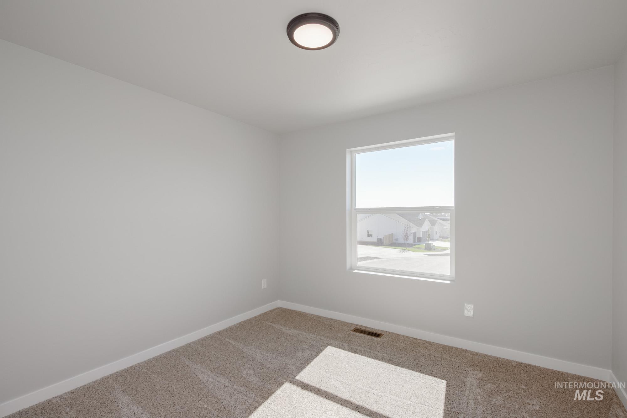 Unfurnished room featuring carpet