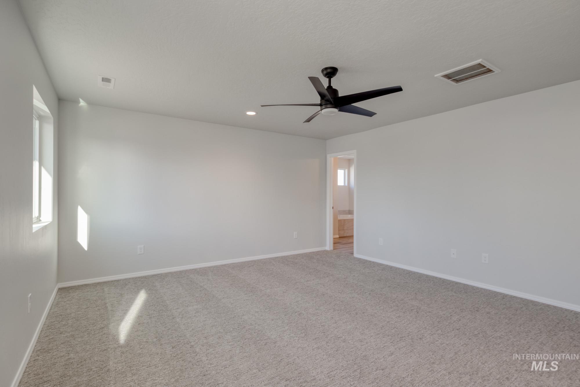 Unfurnished room with carpet, ceiling fan, recessed lighting, and plenty of natural light