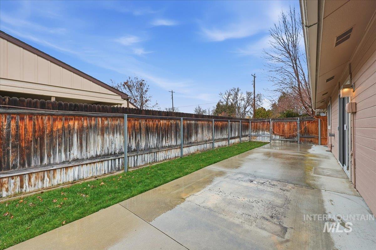 Fenced backyard with a patio area