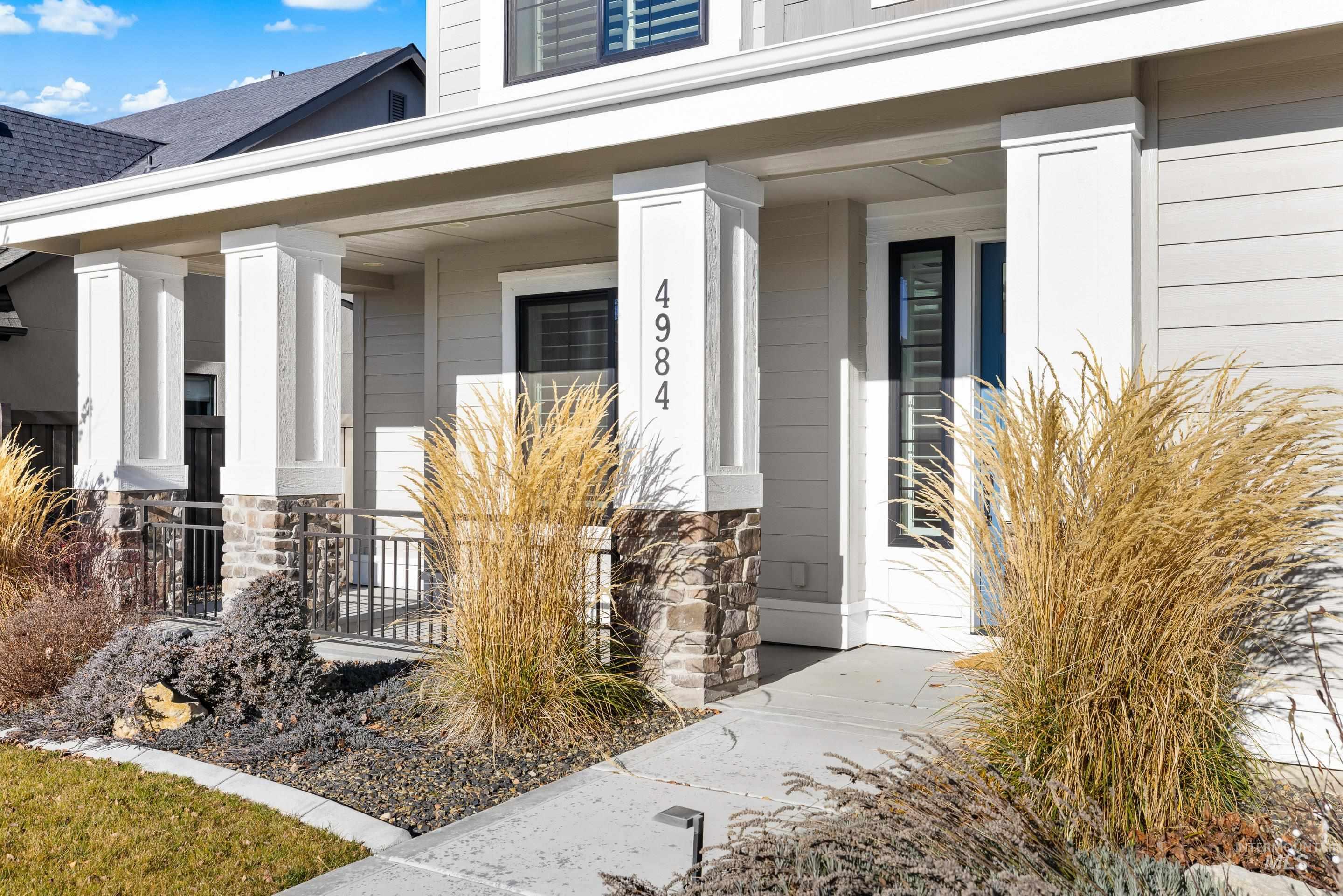 View of exterior entry featuring a porch and stone siding
