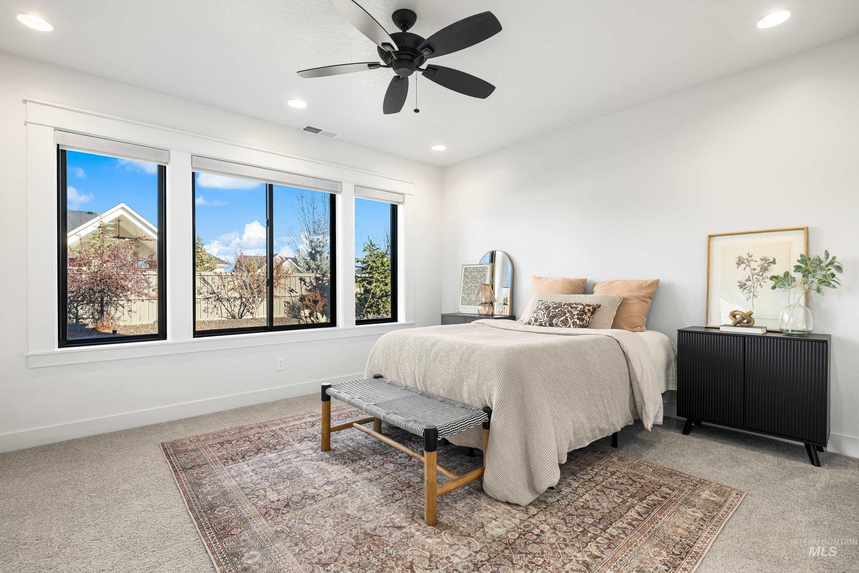 Bedroom with light colored carpet, recessed lighting, and ceiling fan