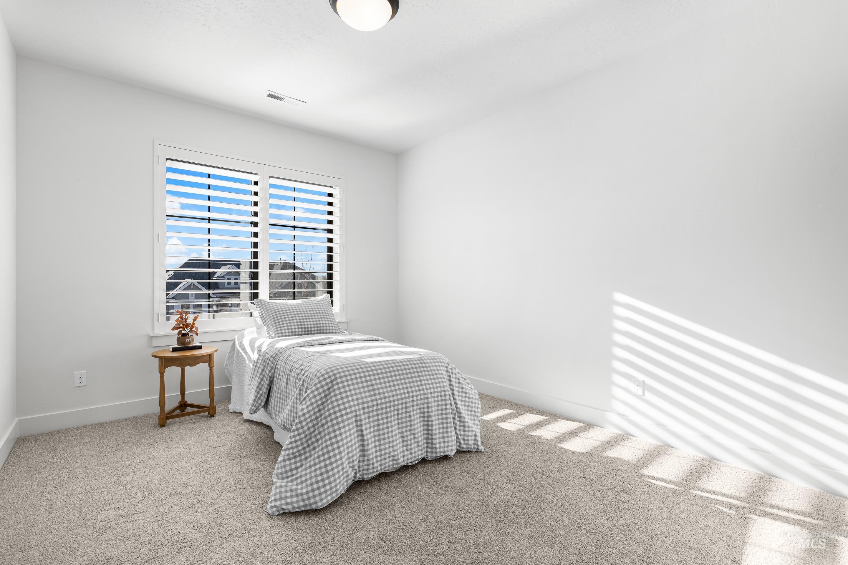 Carpeted bedroom featuring baseboards