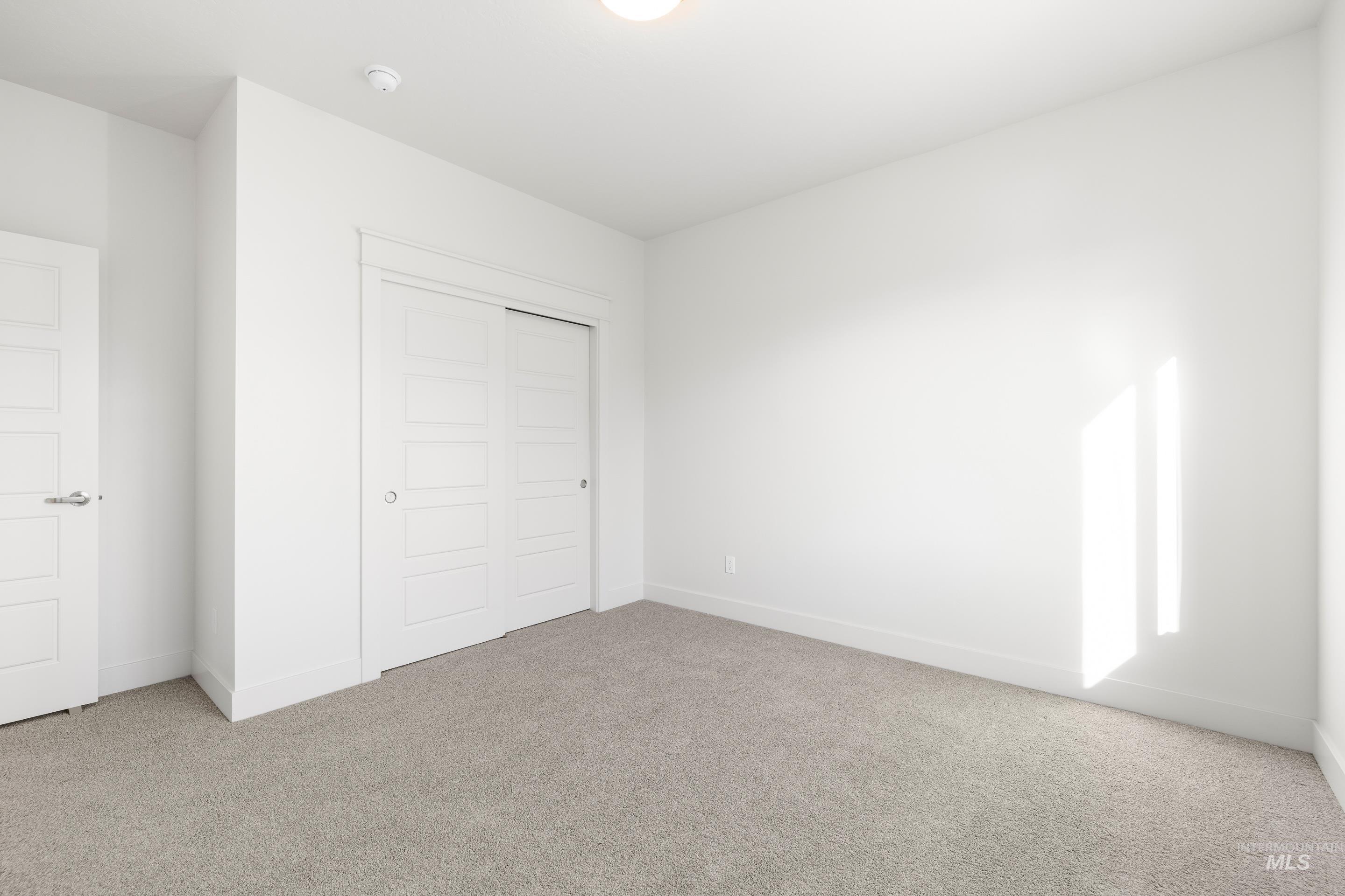 Unfurnished bedroom with carpet and a closet